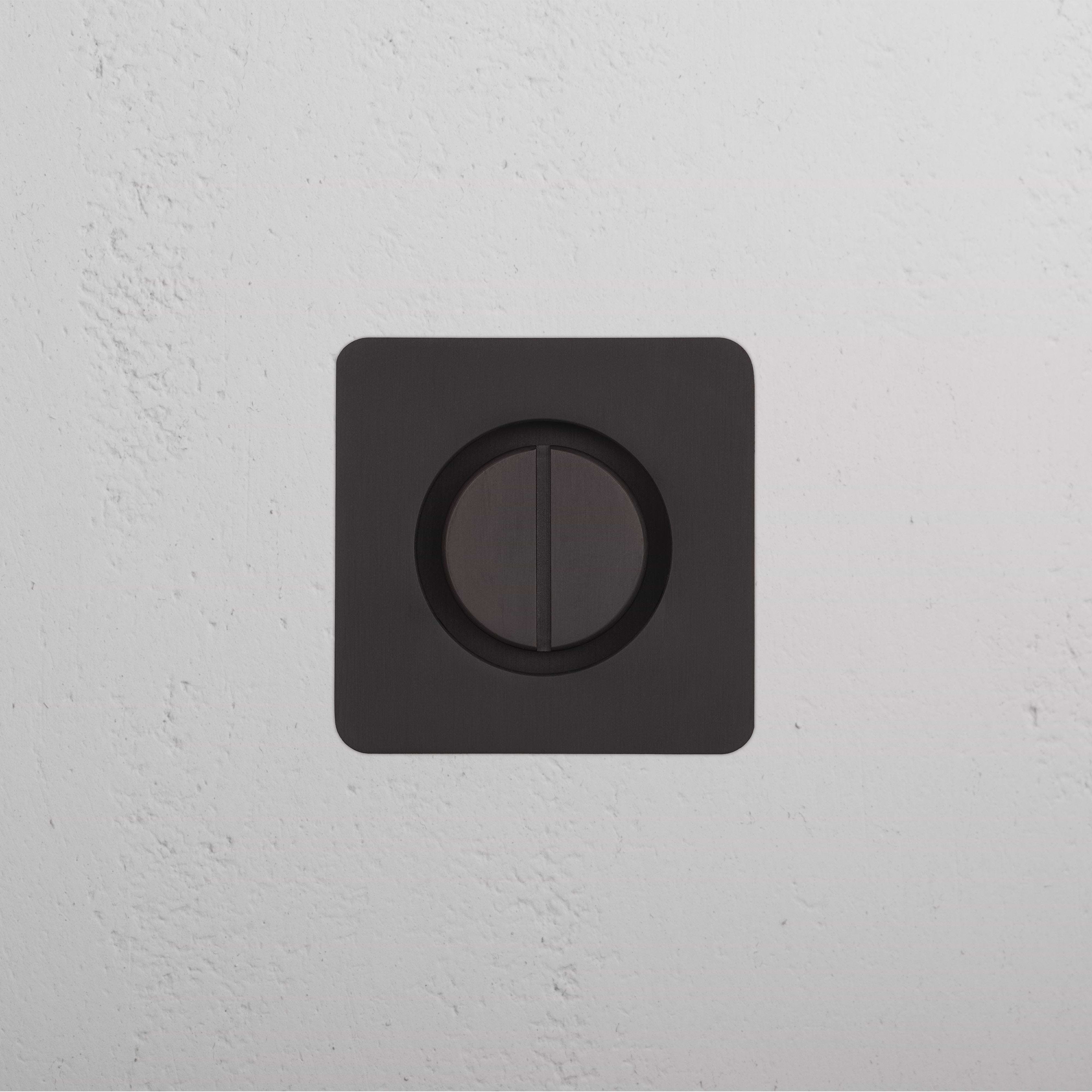 Bronze Regent Recessed Thumbturn with a square faceplate and central thumbturn, mounted on a white wall.