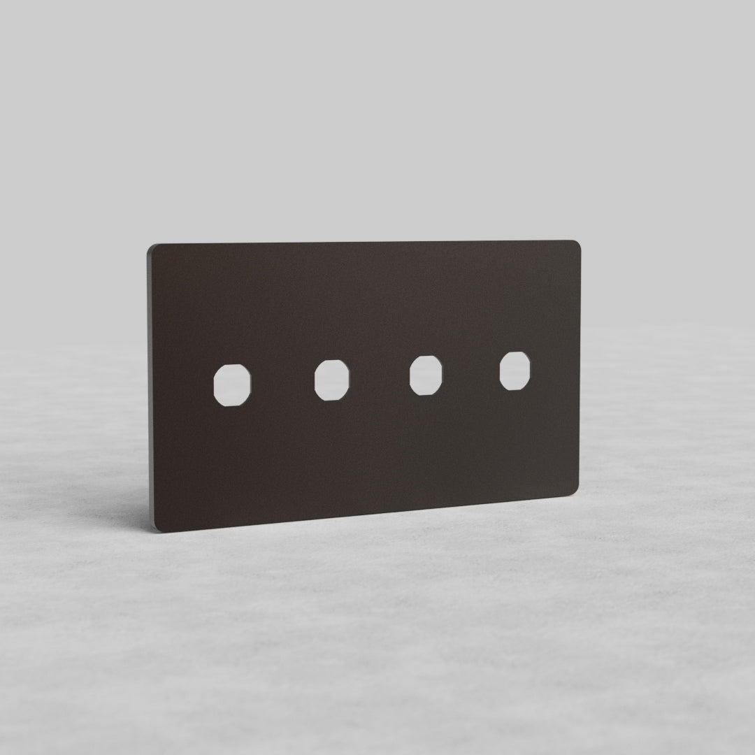 Bronze 4-gang switch plate, Grove US design, with four square cutouts, shown upright on a gray surface.