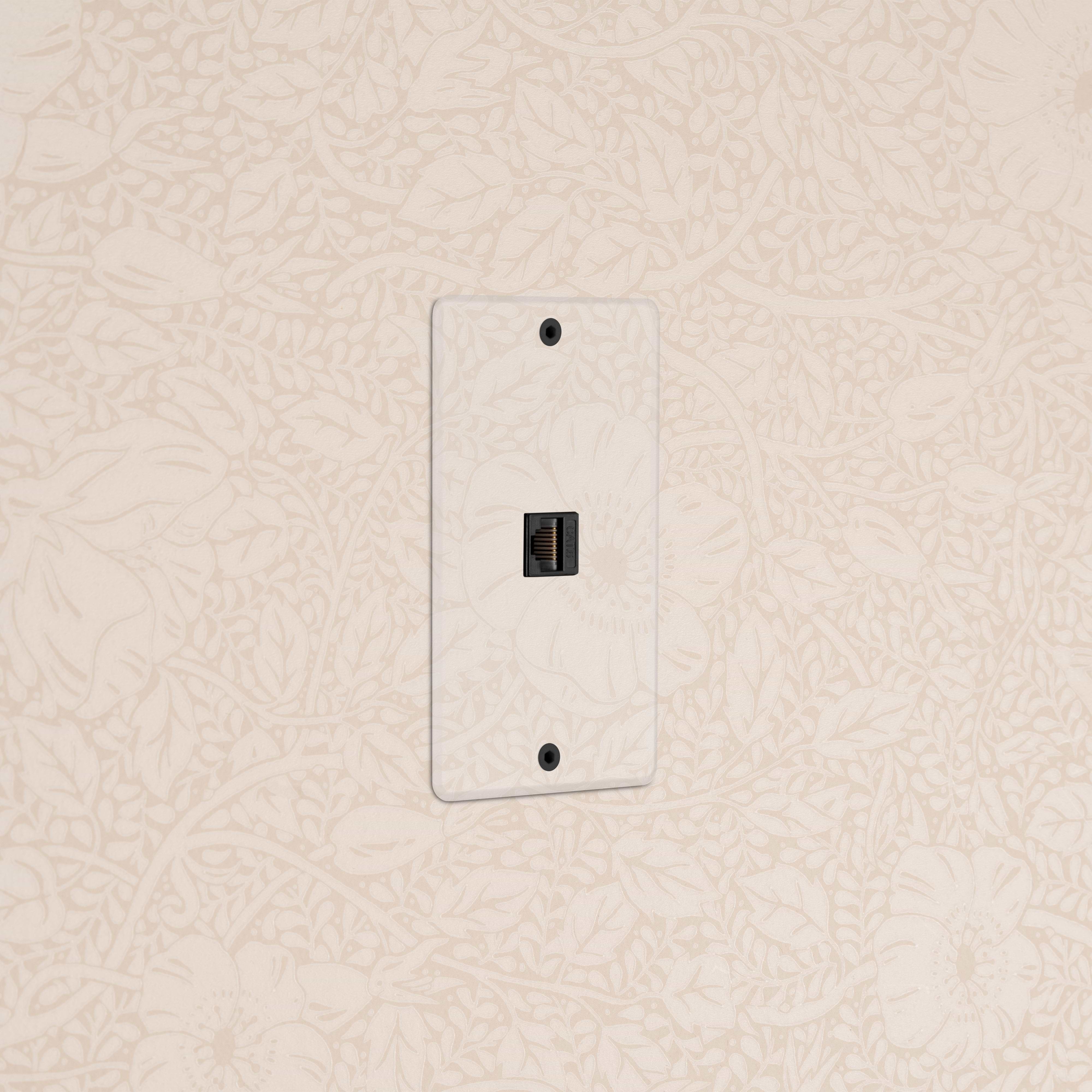 Kew 1G CAT 6 Keystone Ethernet module in clear black, shown mounted on a wall.