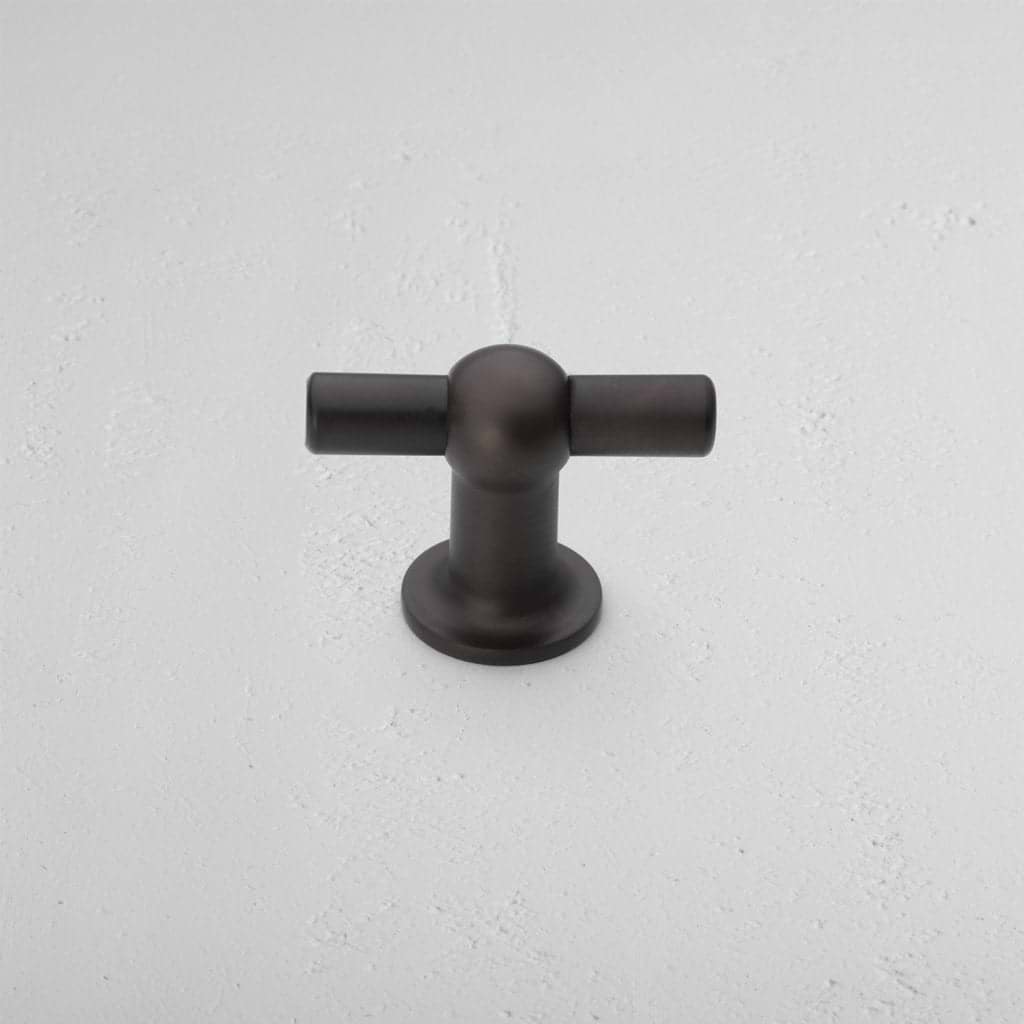 Harper T-Bar Furniture Handle Medium in bronze, featuring a sleek T-shaped design on a white surface.