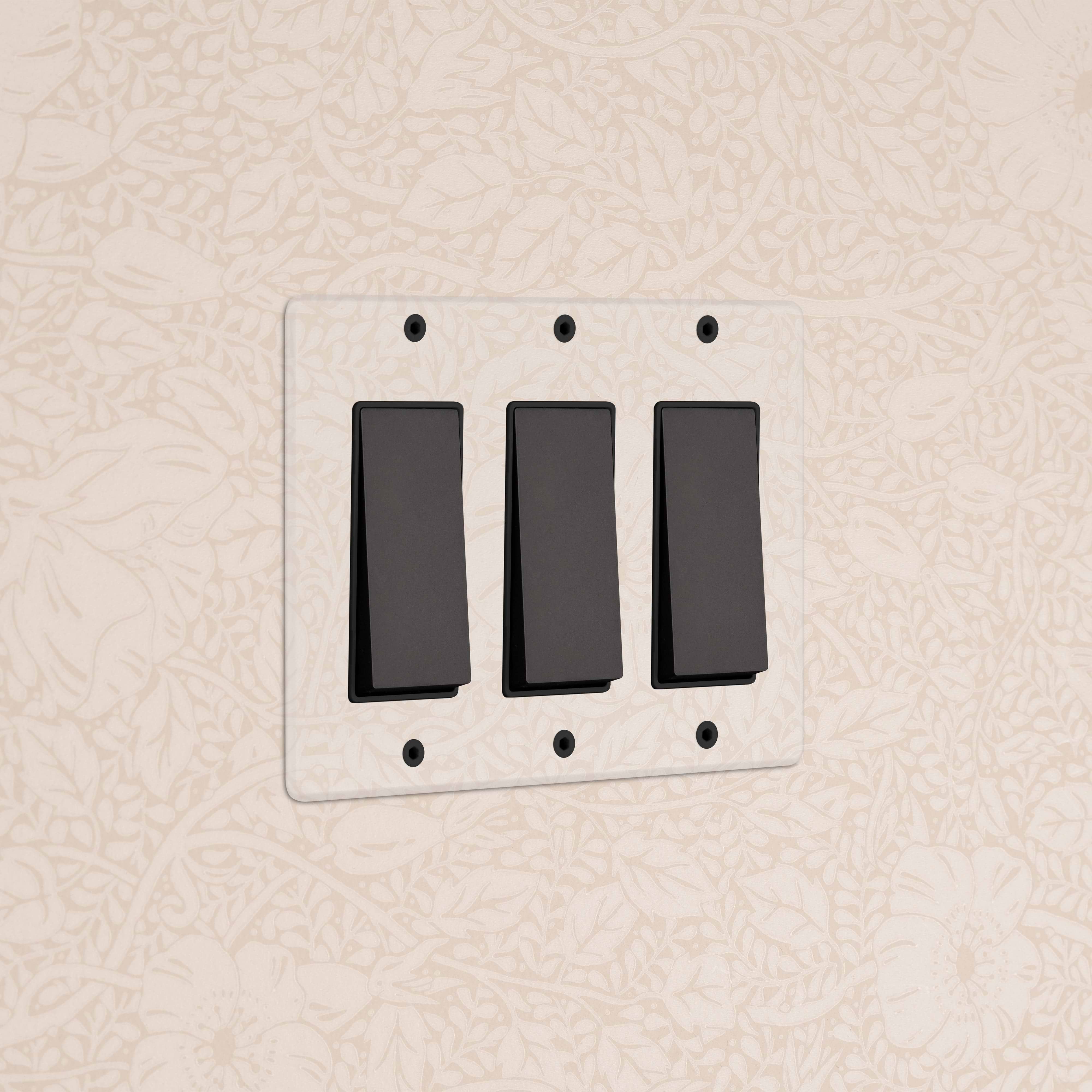 Kew 3G Rocker Switch in Clear Bronze Black with three black switches on a clear bronze rectangular plate.