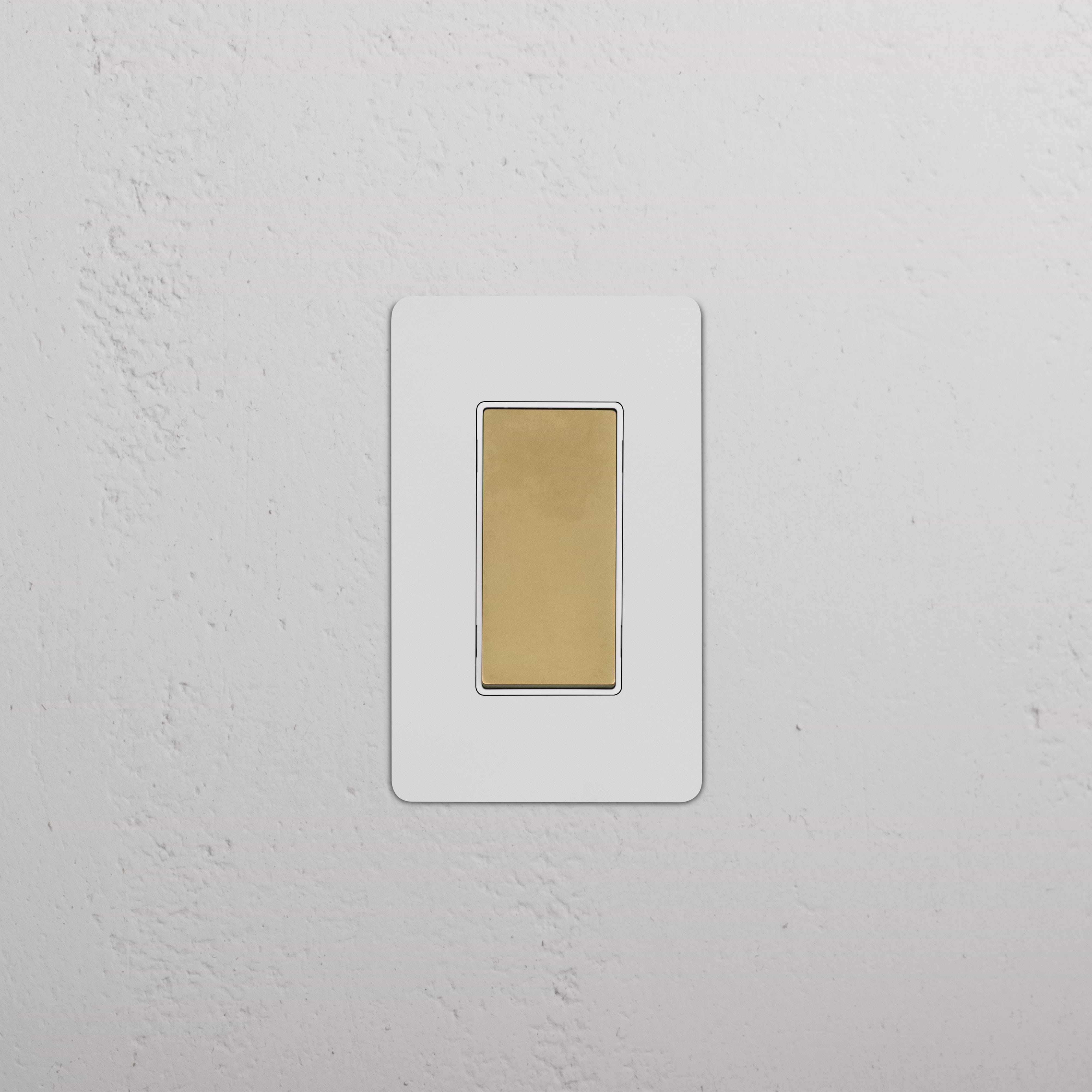 Kew 1G Retractive Rocker Switch in paintable antique brass white, rectangular with white trim.