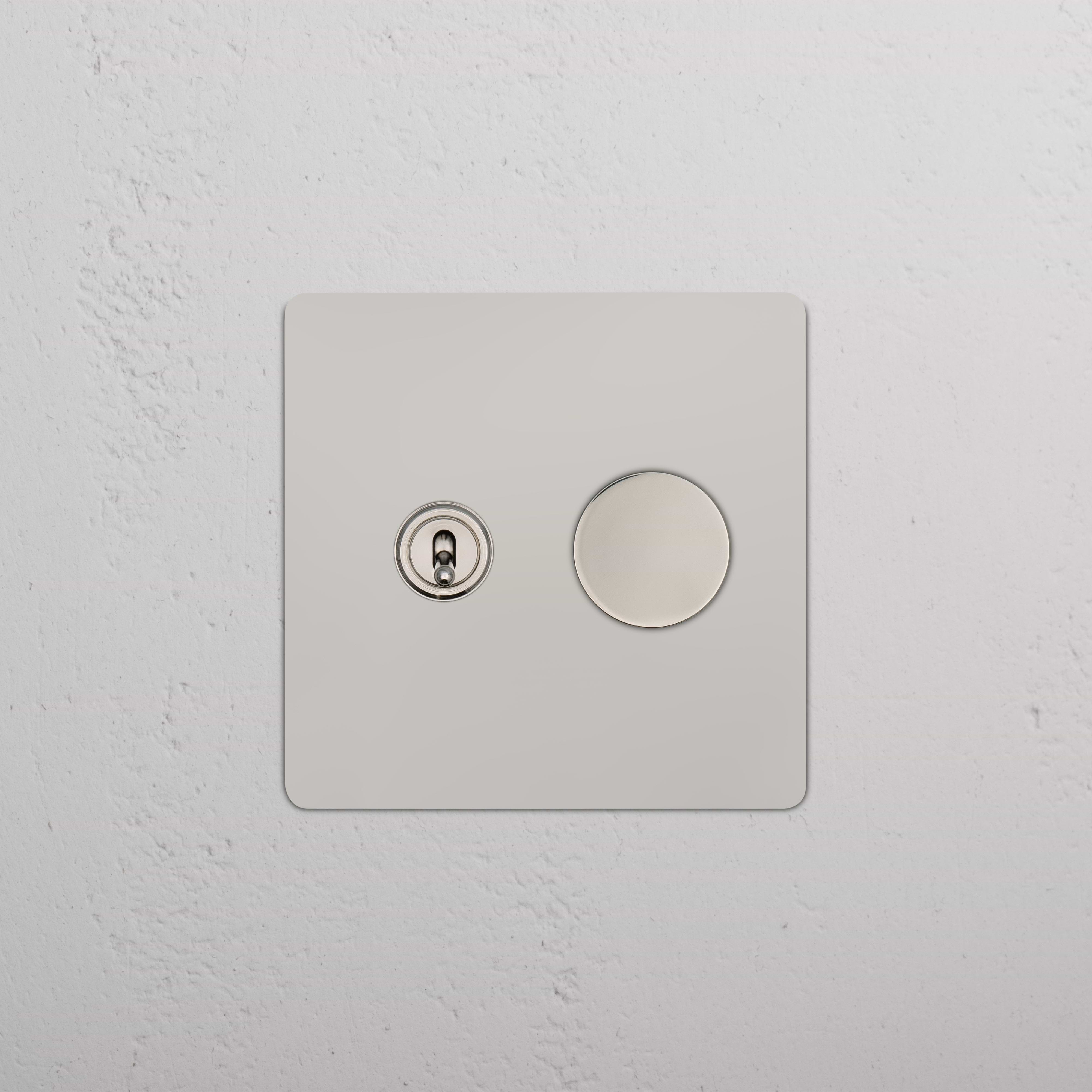Kew 2G Toggle & Dimmer Switch in polished nickel with two controls on a sleek square panel, wall-mounted.