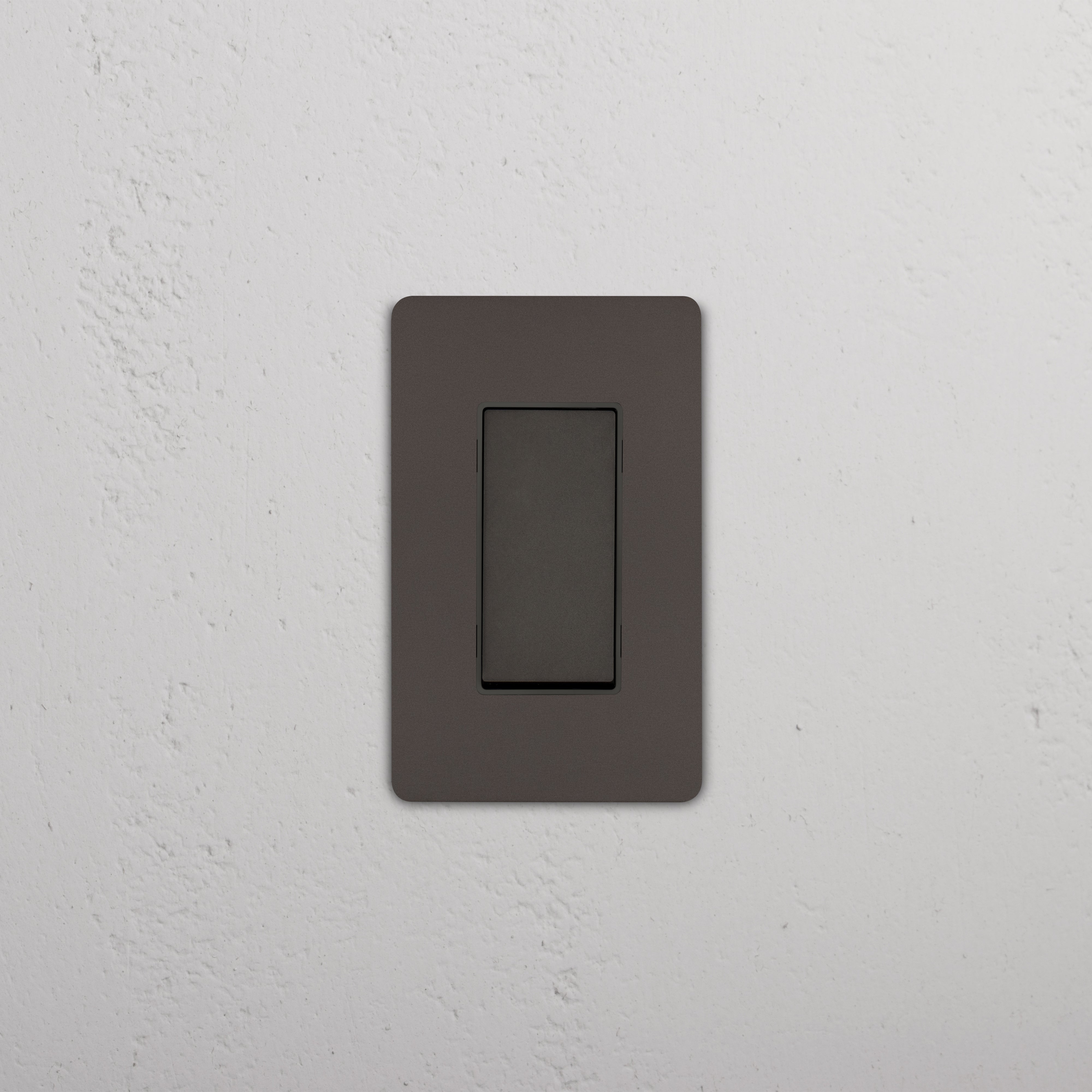 Grove 1G Smart Retractive Rocker Switch in Bronze Black, rectangular design, mounted on white textured wall.