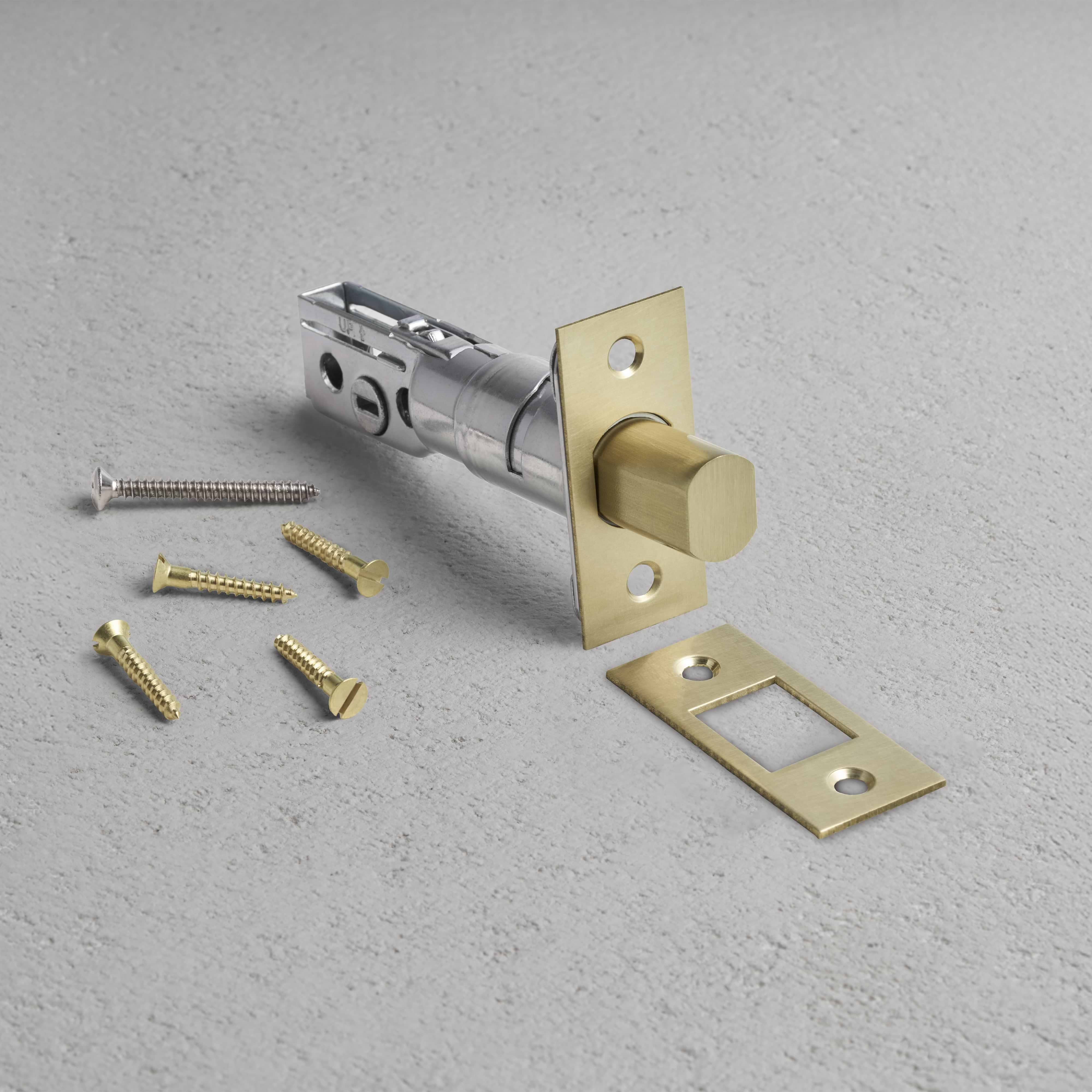 Tubular Privacy Deadbolt in Antique Brass finish with matching strike plate and screws on a light gray surface.