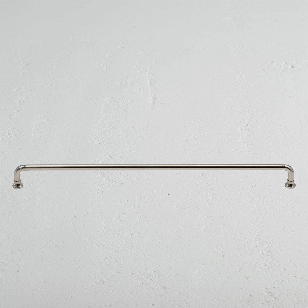 Large Sycamore furniture handle in polished nickel finish, mounted horizontally on a light wall.
