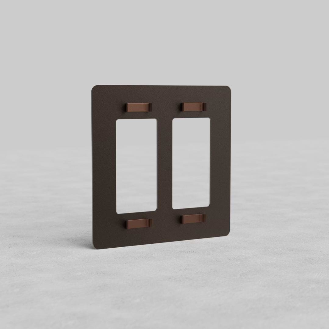Bronze 2G Outlet Plate Kew US with two vertical rectangular cutouts, shown on a light gray surface.
