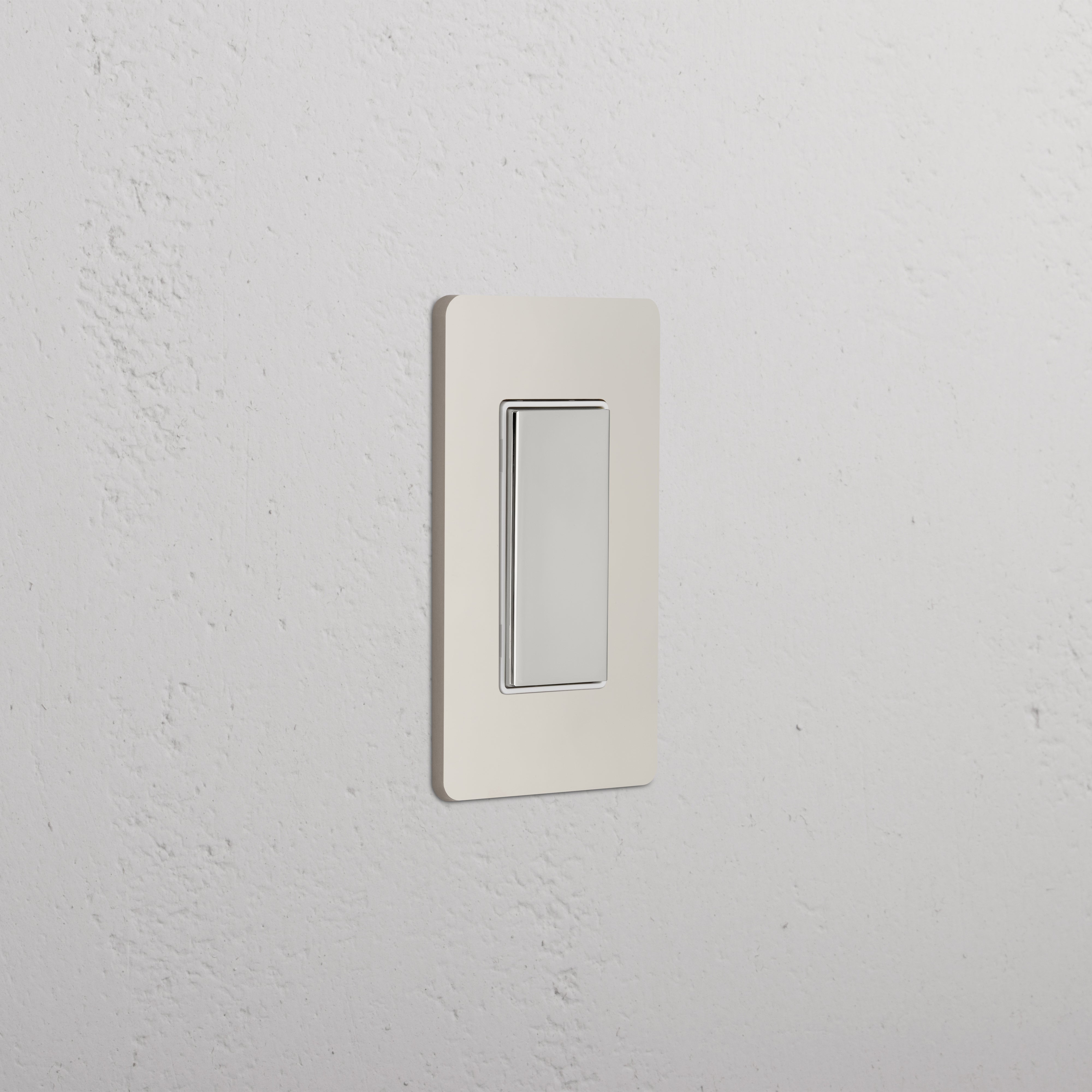 Grove 1G Center Retractive Rocker Switch in polished nickel white, mounted on a white wall.