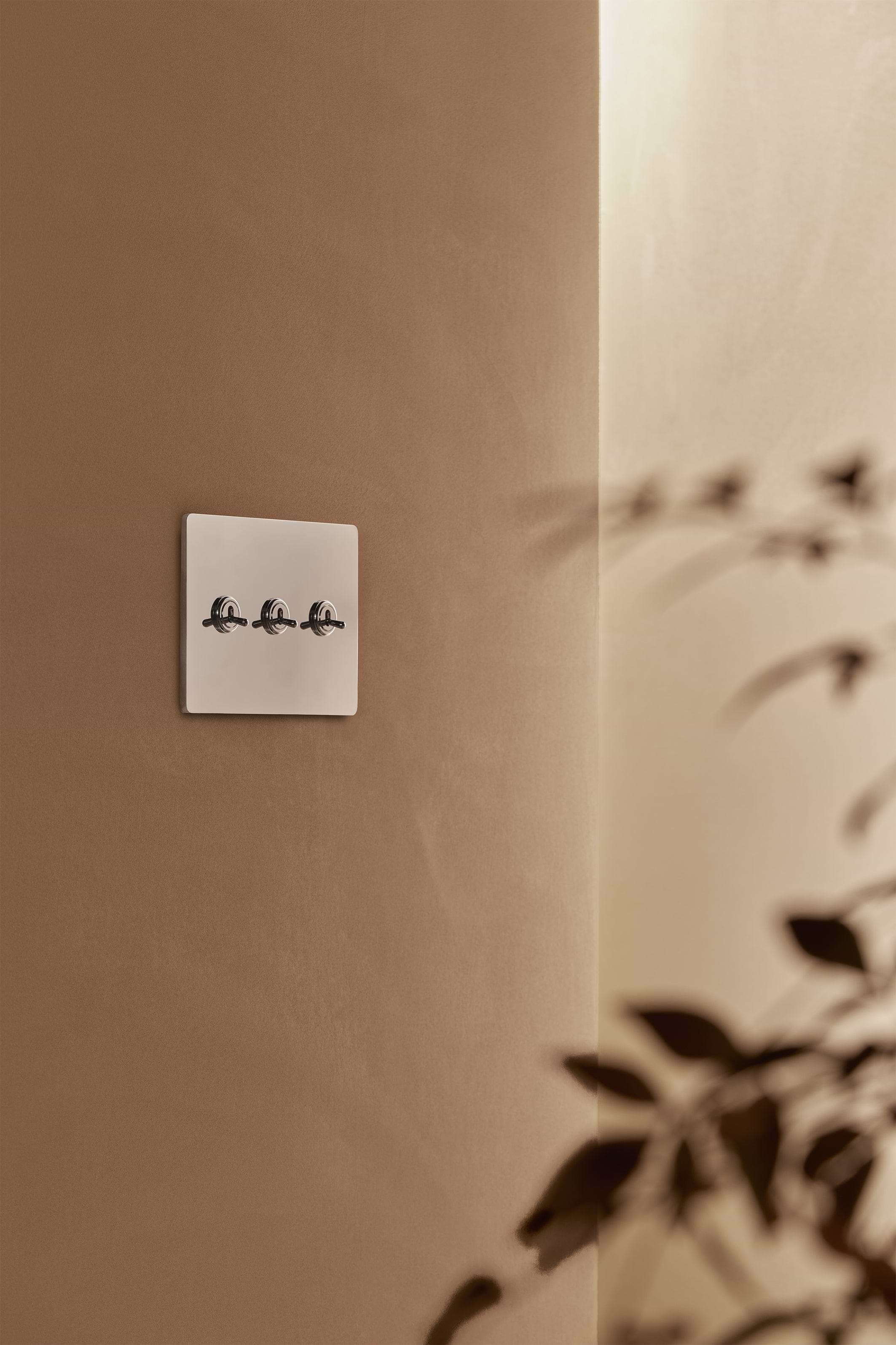 Grove 3G Toggle Switch in polished nickel on a white wall plate, designed for modern interiors.