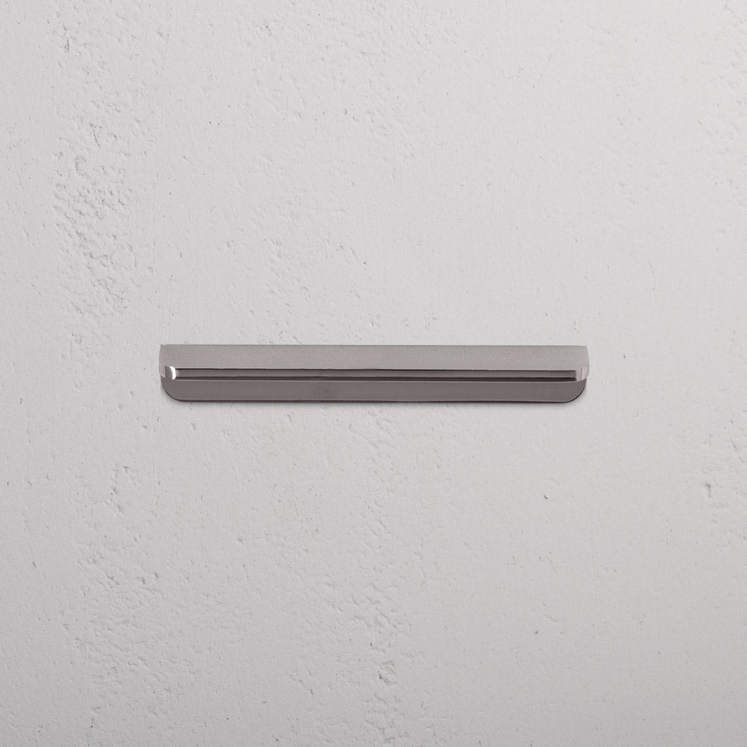 Oxford Furniture Handle Small in polished nickel, a sleek metallic handle with rounded ends on a white surface.