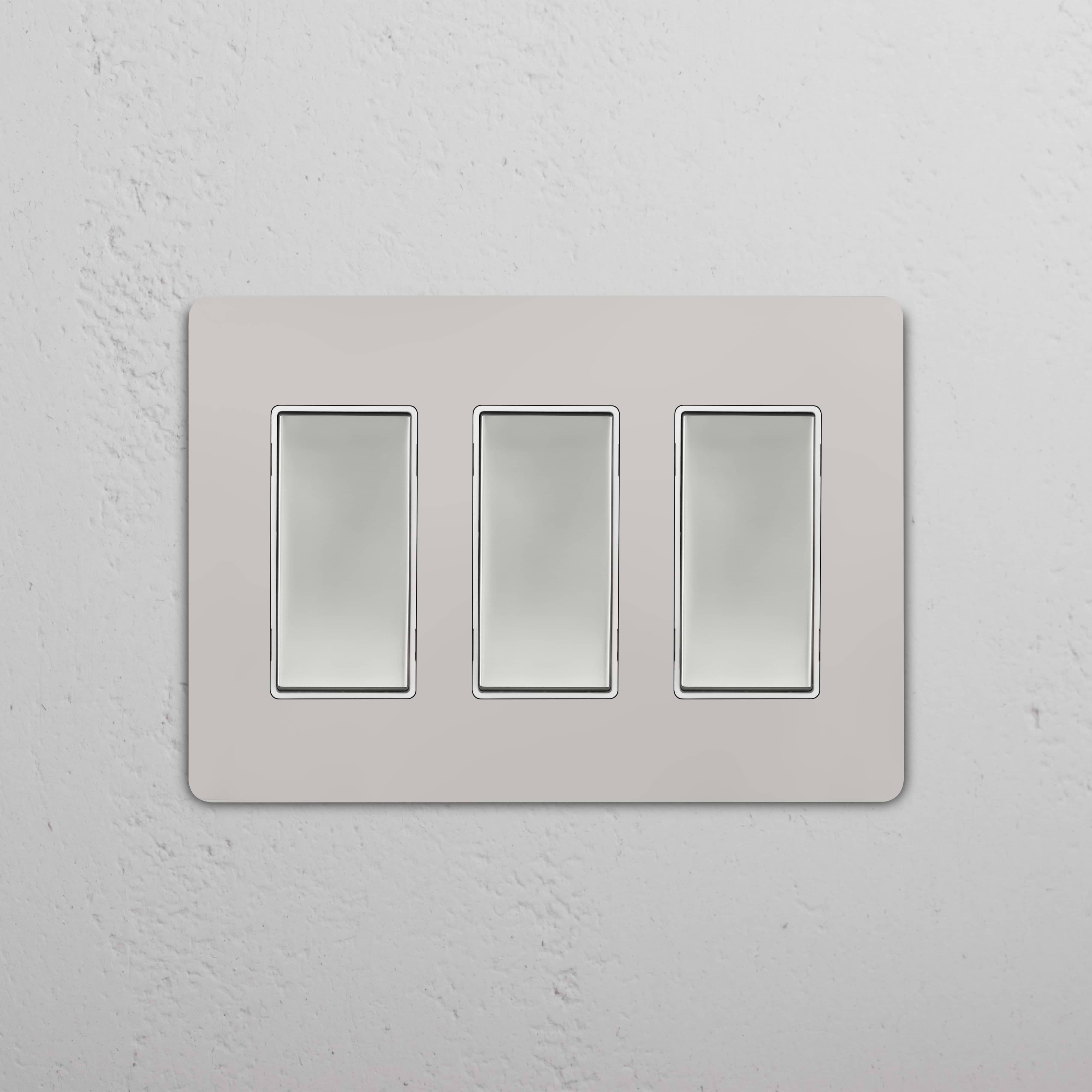 Grove 3G Rocker Switch in Polished Nickel White with three rectangular switches on a white mounting plate.