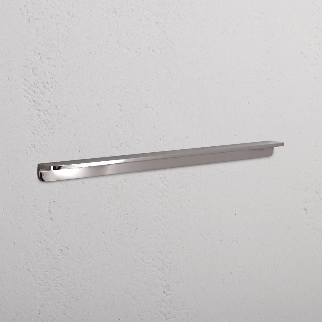 Large polished nickel Oxford Furniture Handle with a sleek, modern design mounted horizontally on a white surface.