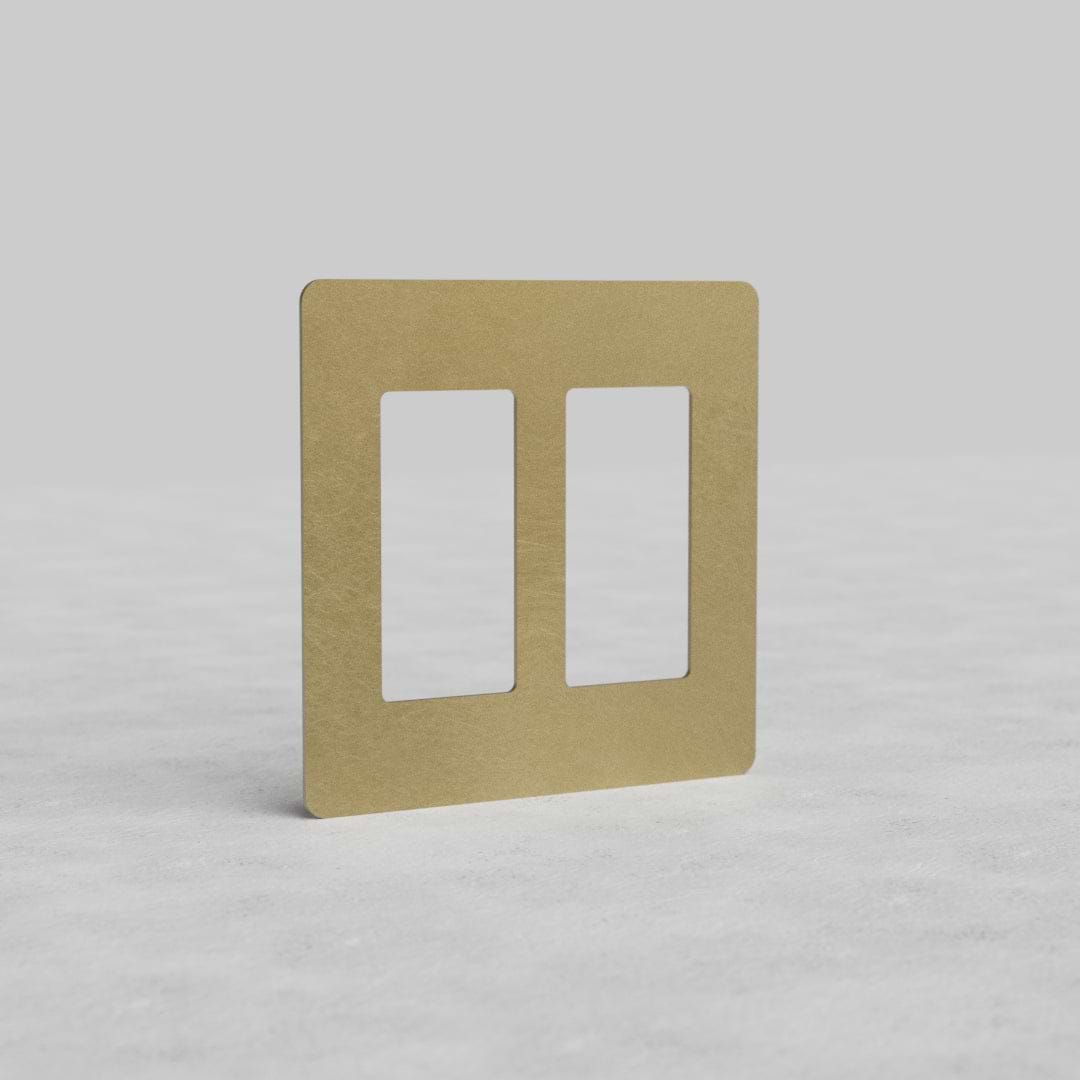 Antique brass 2G outlet plate Kew US with two vertical cutouts on a light background.