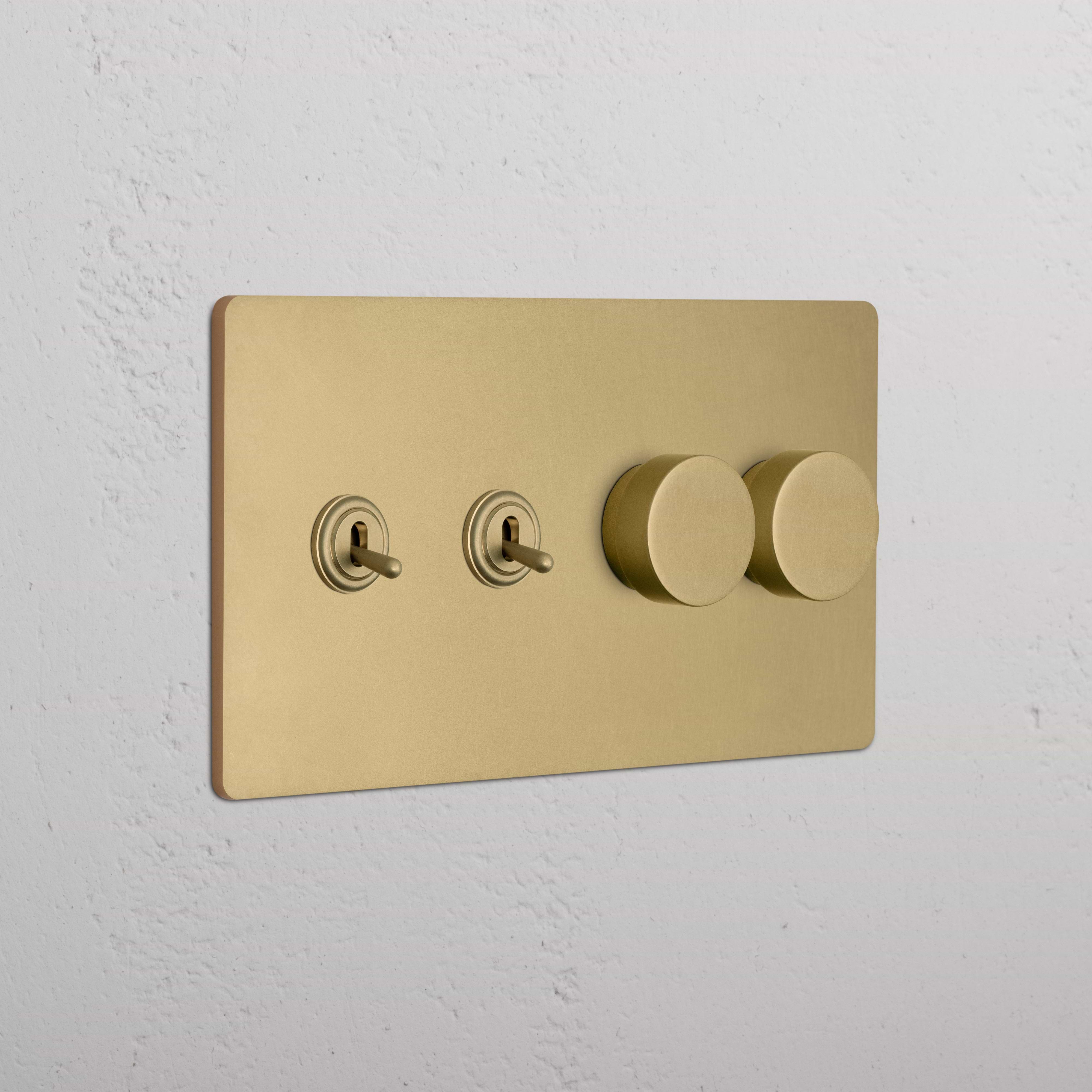 Grove 4G switch in antique brass with 2 toggle and 2 dimmer switches, mounted on a white wall.