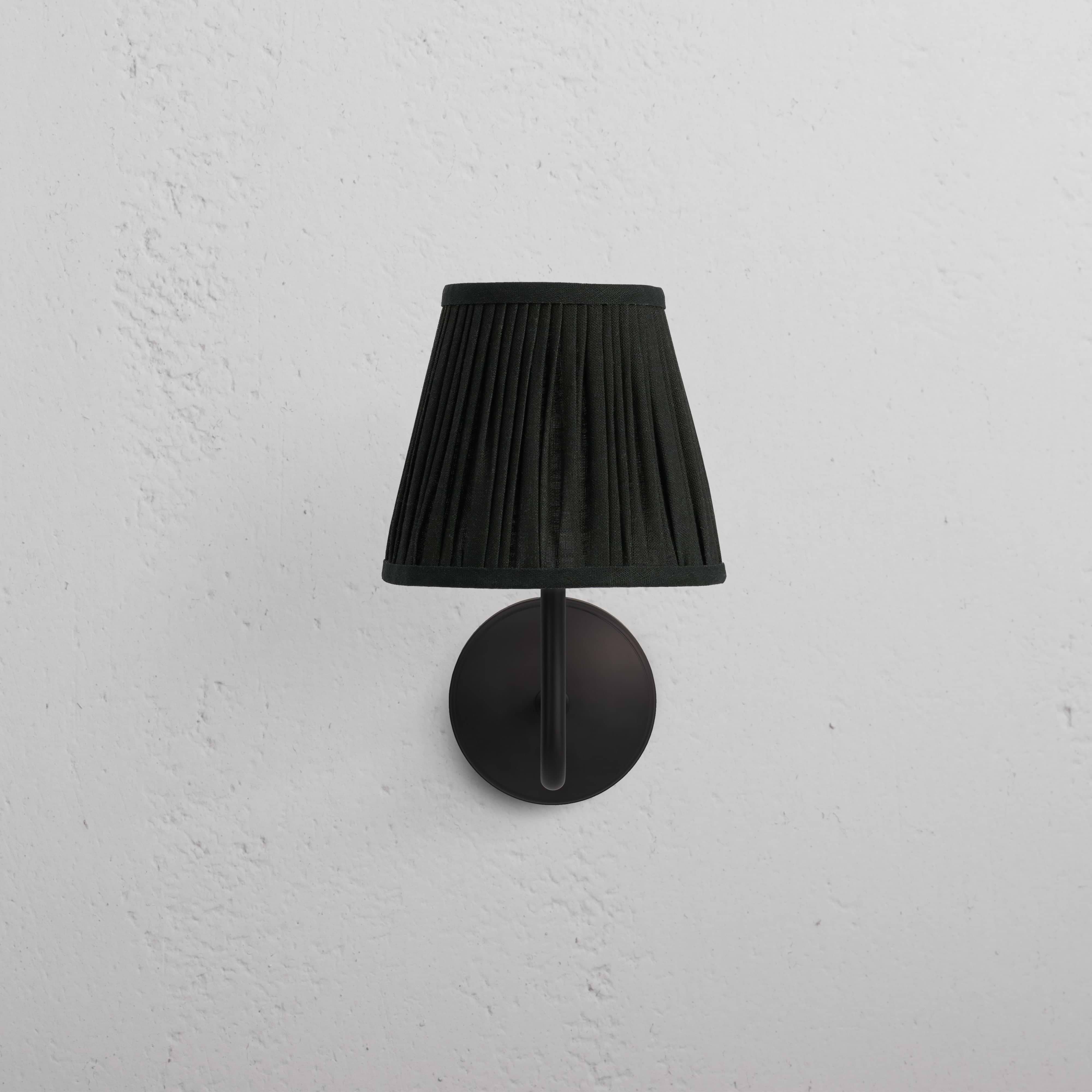 Malvern Medium Wall Light Deep Green - Bronze with pleated shade and bronze details on a white wall.