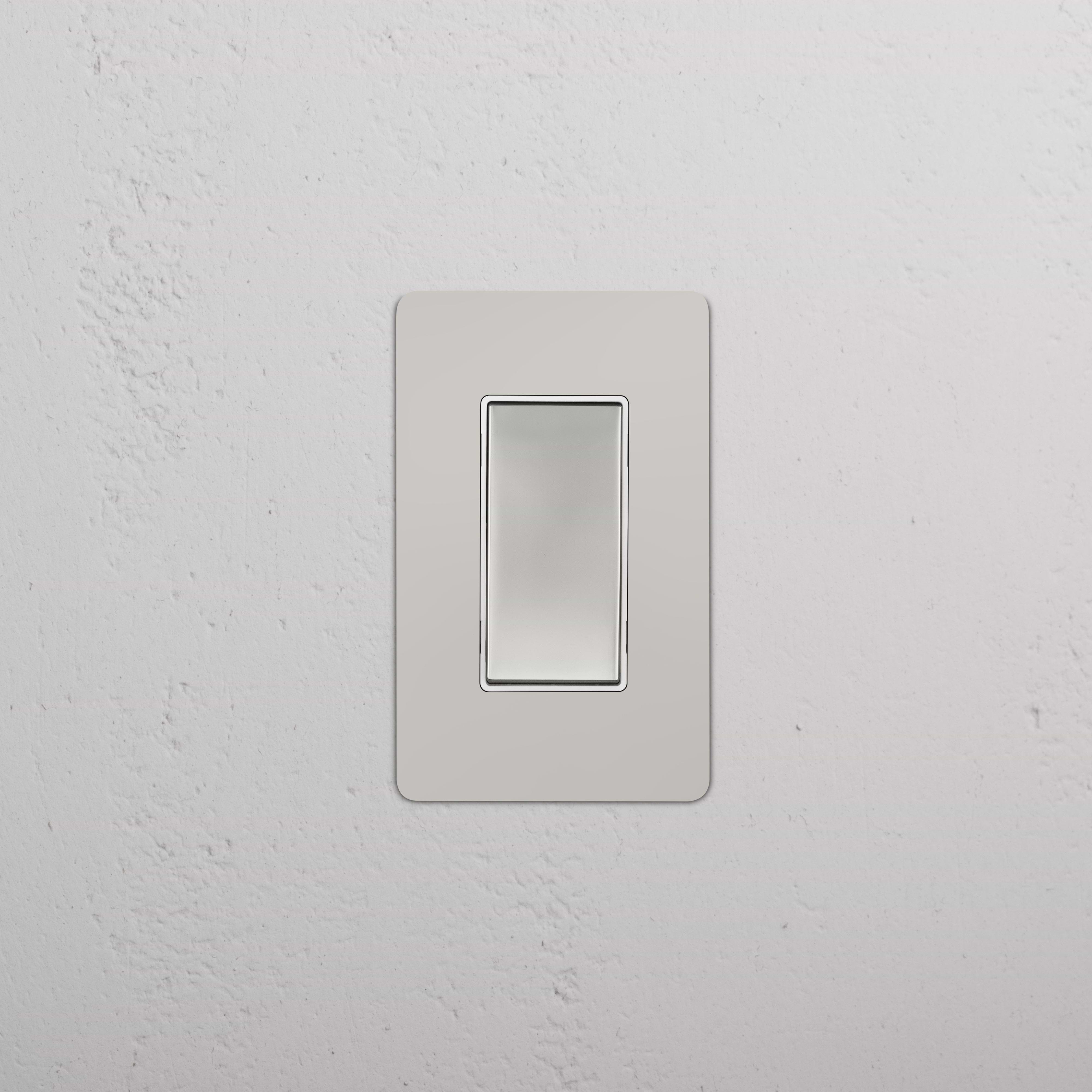 Kew 1G Double Pole Rocker Switch in polished nickel white finish, installed on a white wall.