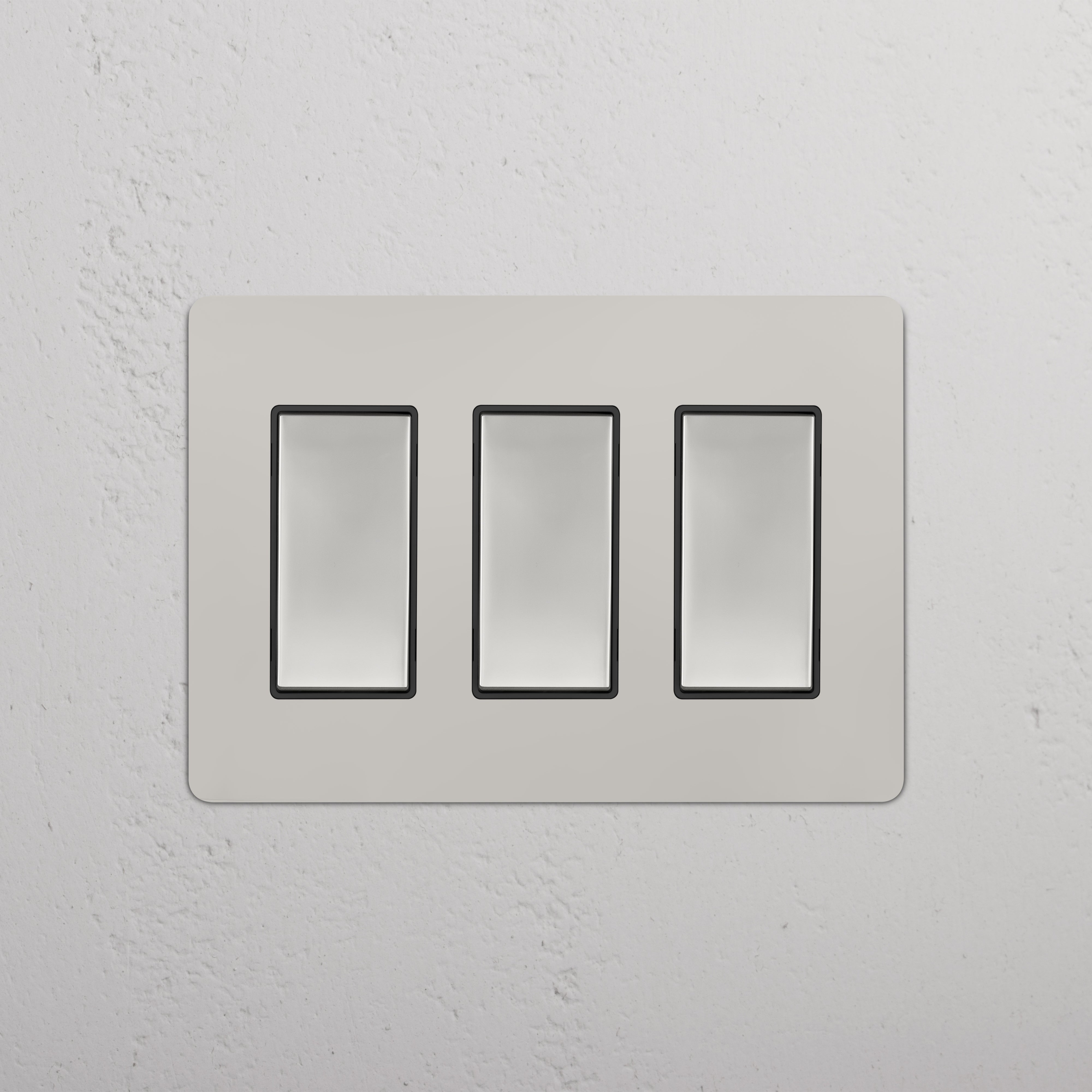 Kew 3G Rocker Switch in Polished Nickel Black with three rectangular switches on a sleek wall plate.