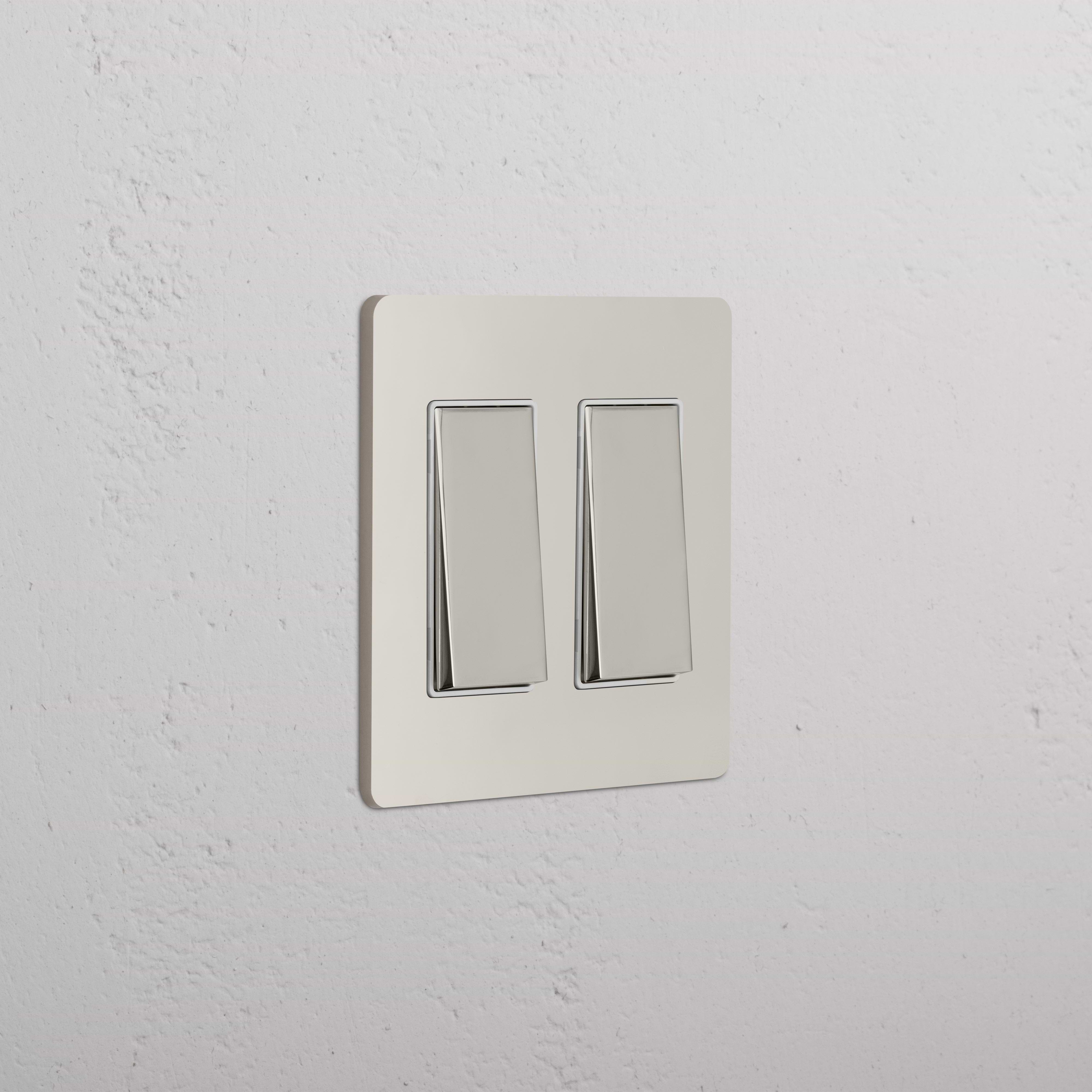 Grove 2G Rocker Switch in Polished Nickel White with two rectangular switches, mounted on a white wall.