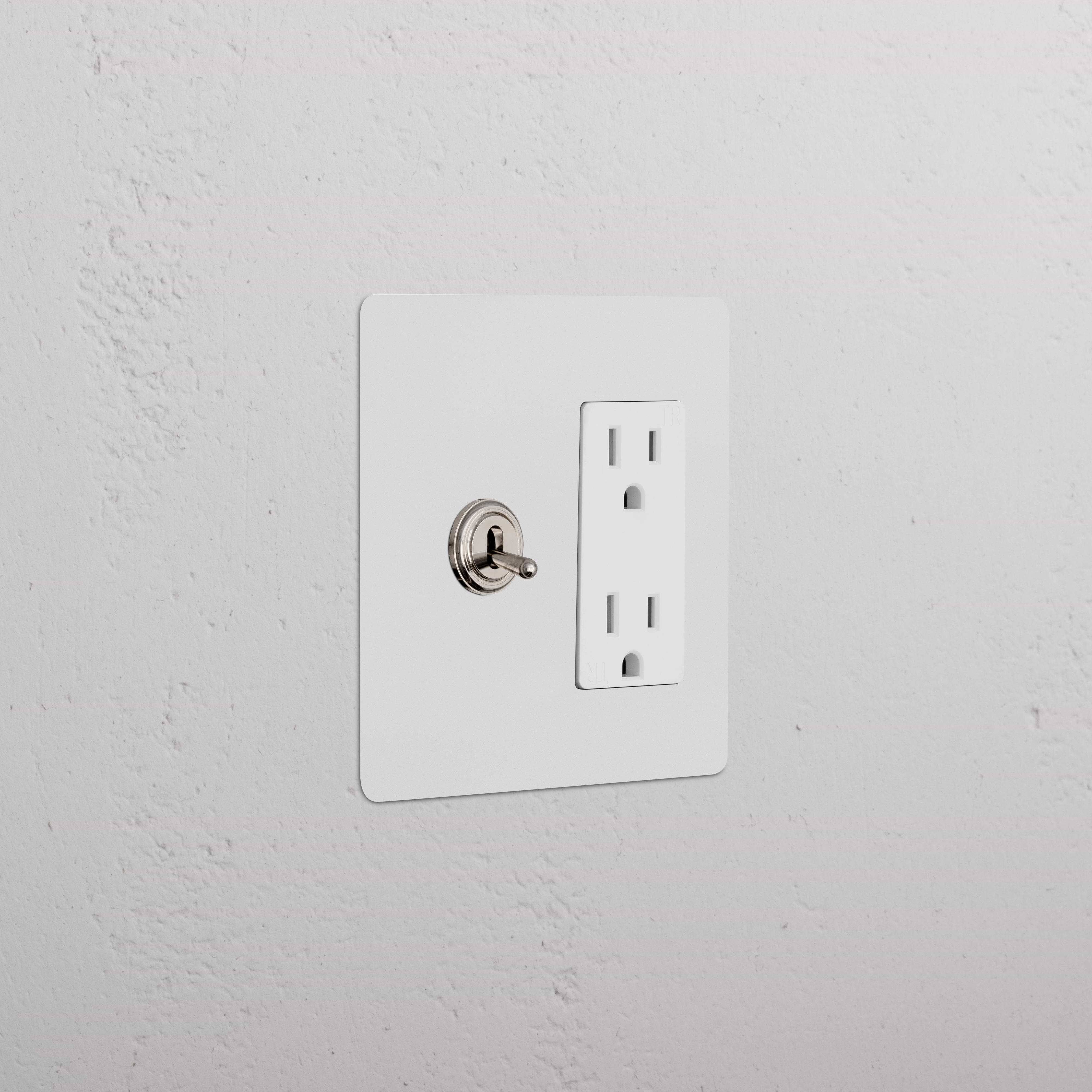 Kew 2G Toggle Switch & Outlet in paintable polished nickel white on a white wall, showing two toggles and sockets.