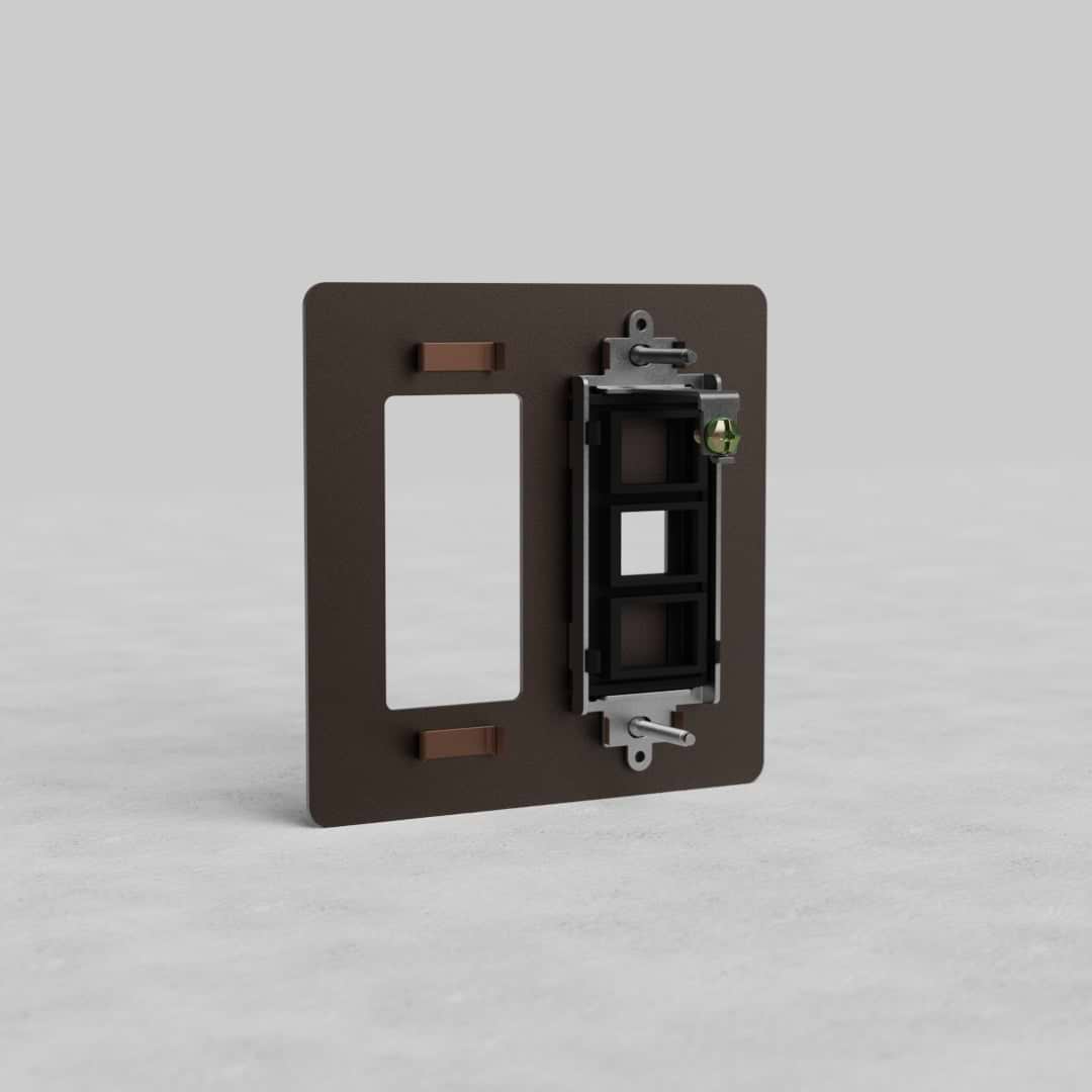 Bronze 2G Outlet & Keystone Plate Kew US with black keystone insert on a light gray surface.