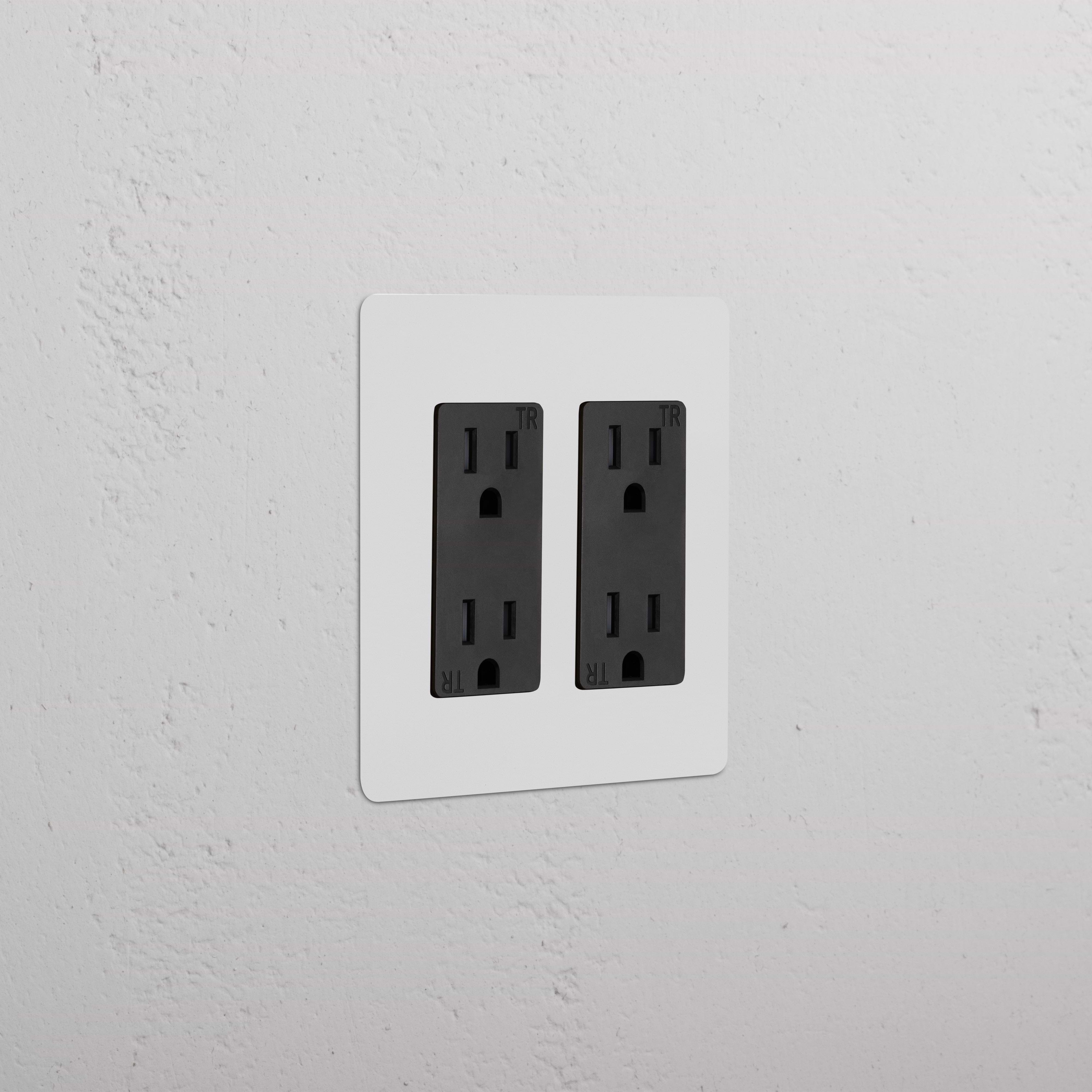 Kew 2G Outlet - Paintable Black double socket with a sleek, paintable black finish on a wall.