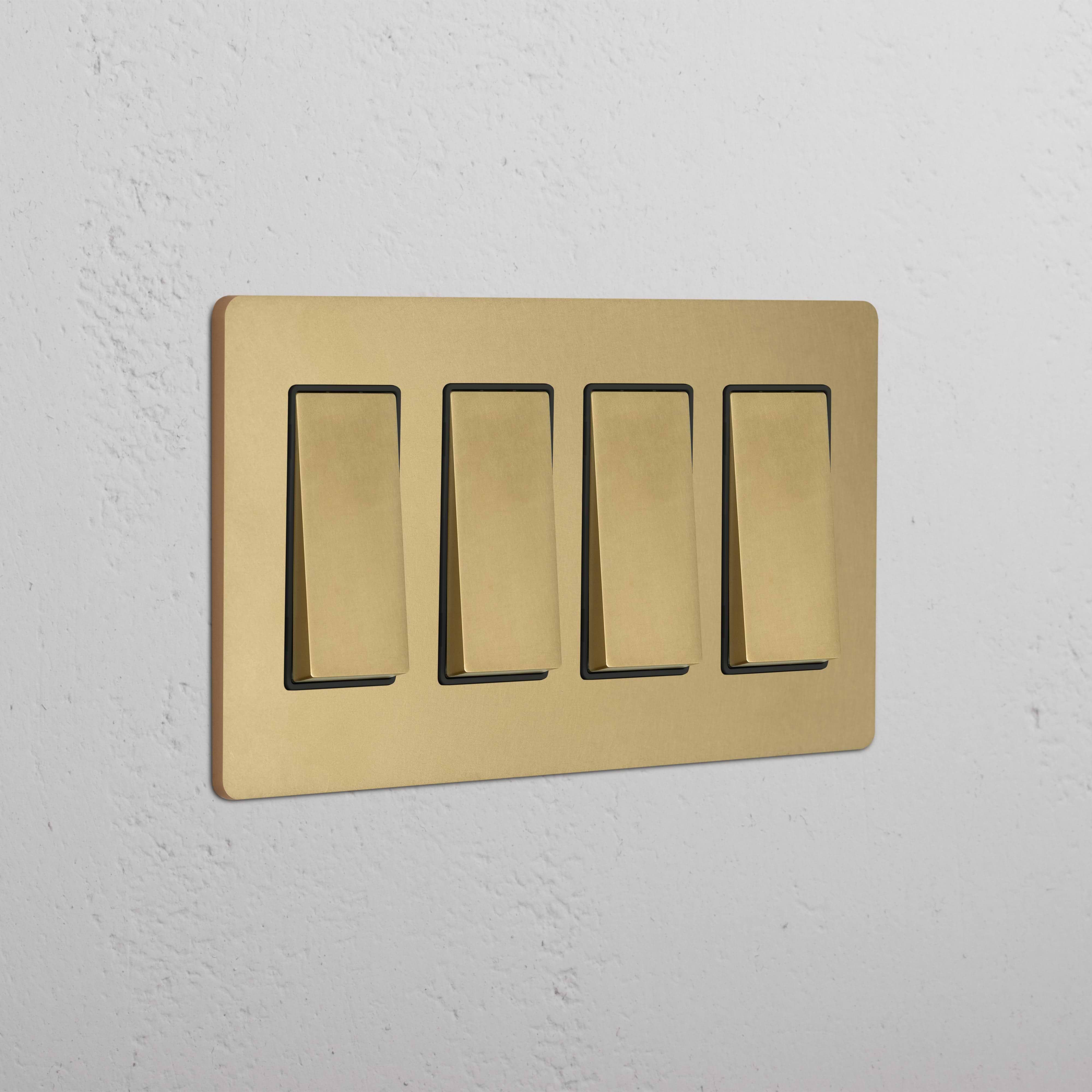 Grove 4G Rocker Switch in Antique Brass Black with four rectangular switches on a white wall.