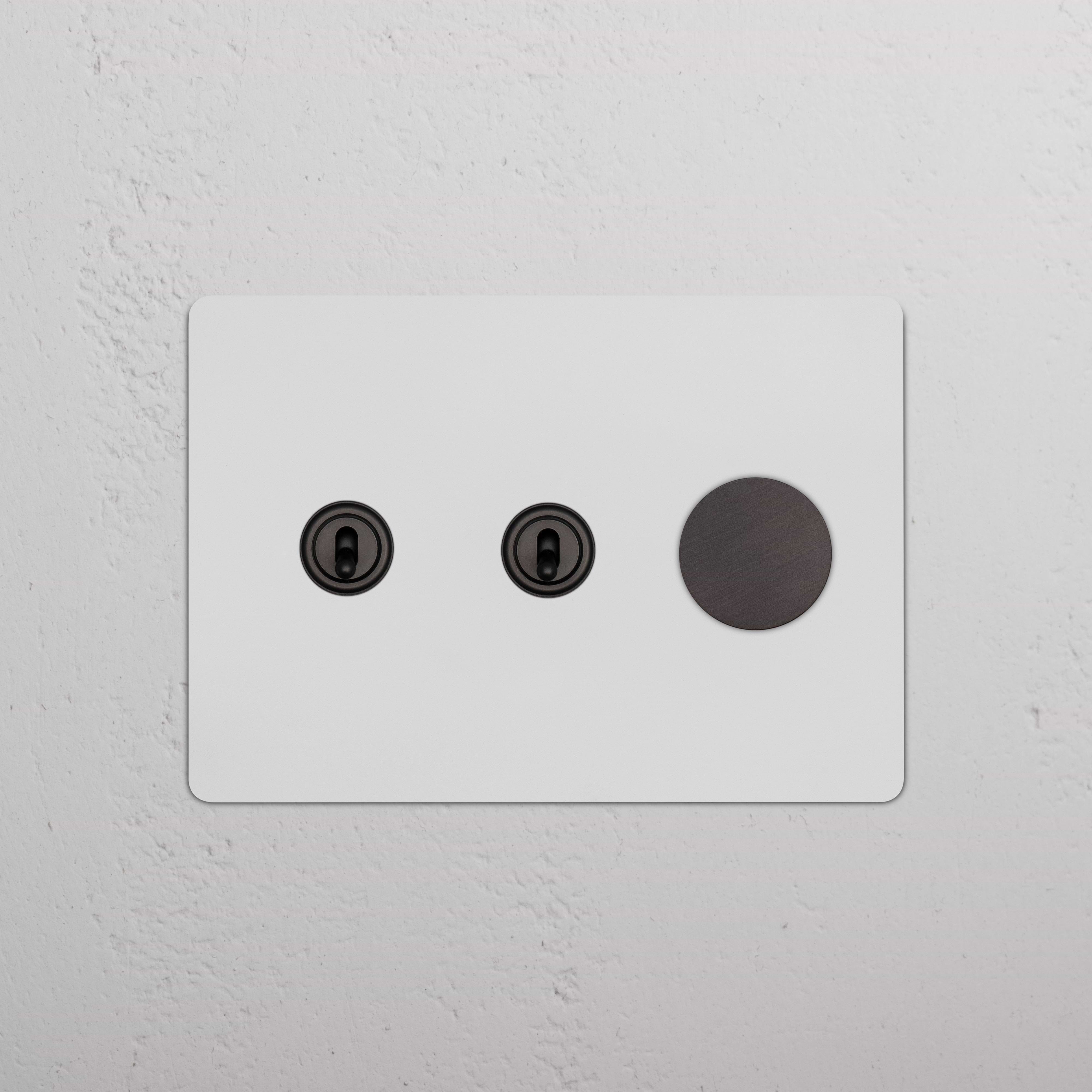 Kew 3G 2x Toggle & Dimmer Switch in paintable bronze finish, featuring two toggles and one dimmer knob.