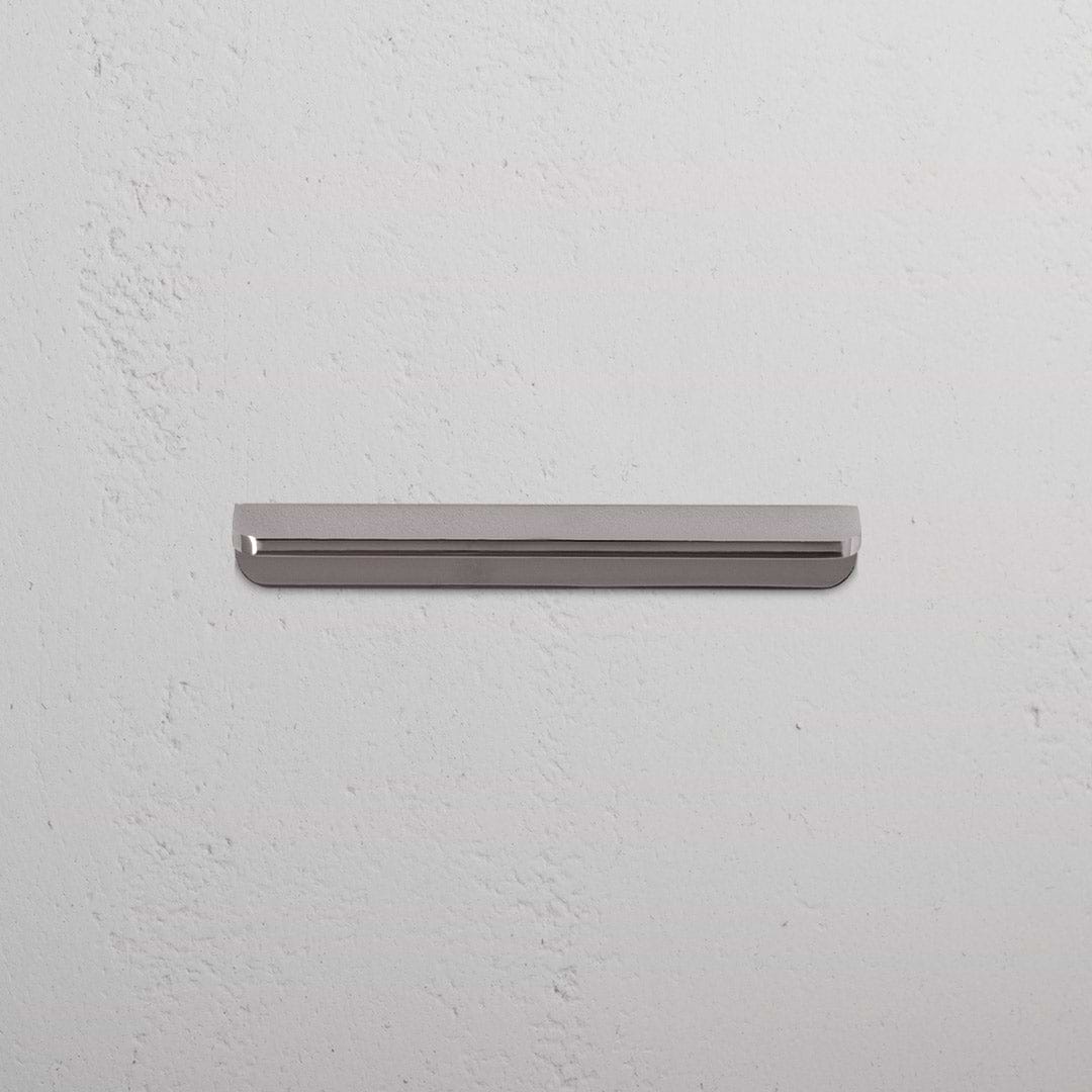 Oxford Furniture Handle Small in polished nickel, a sleek metallic handle with rounded ends on a white surface.