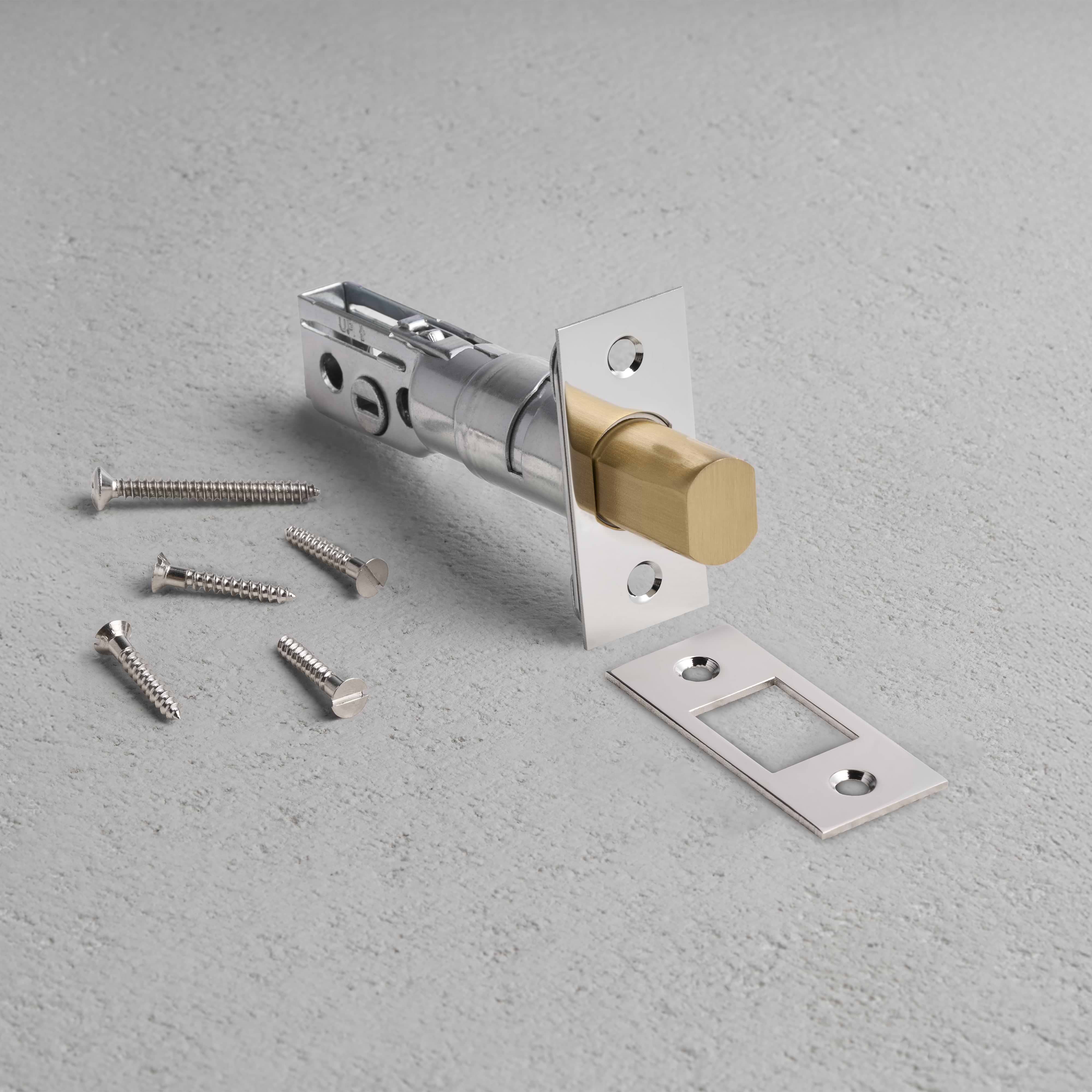 Tubular Privacy Deadbolt in Polished Nickel with strike plate and screws on a light gray surface.