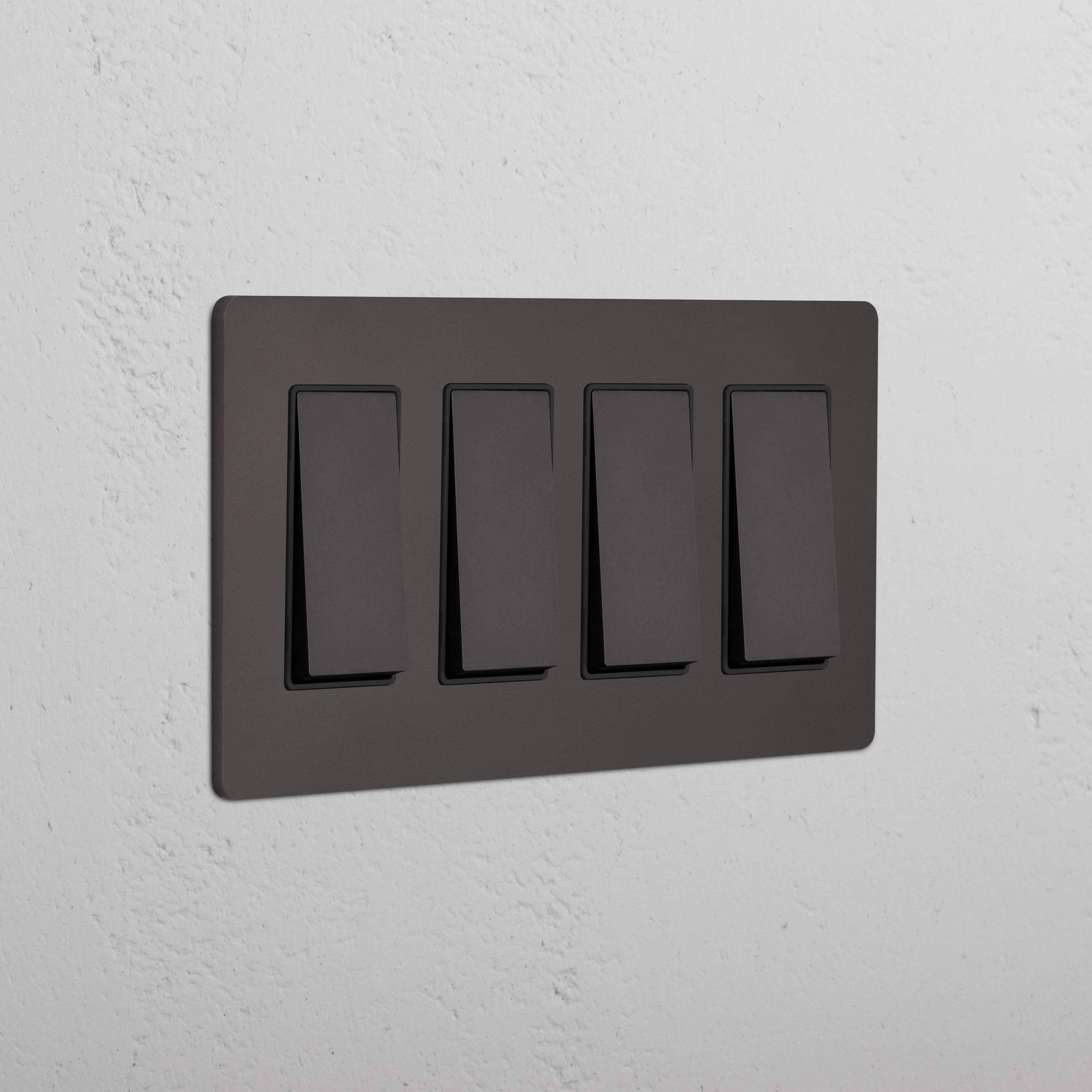 Grove 4G Rocker Switch in Bronze Black with four black rocker switches, mounted on a white textured wall.