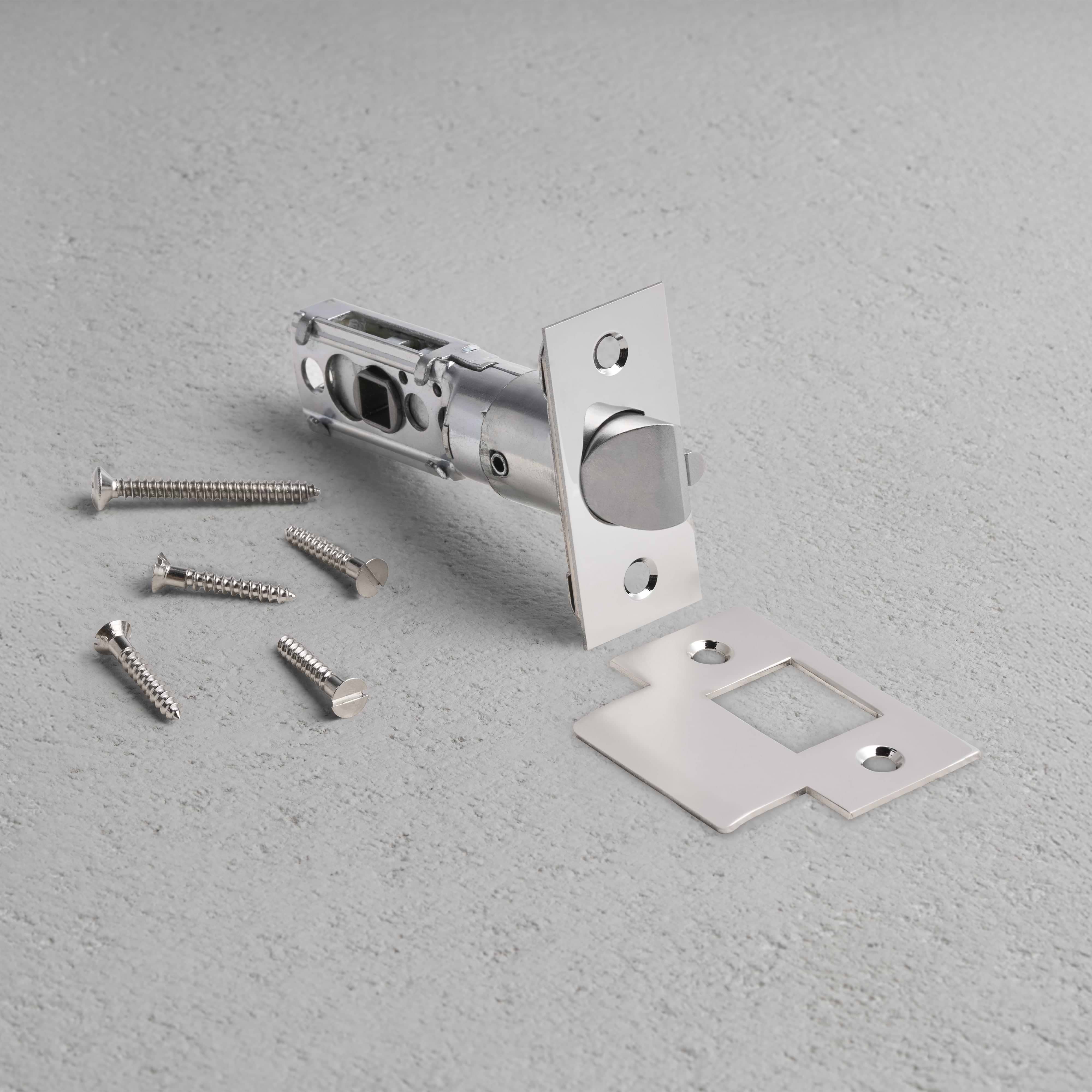 Passage Tubular Latch in polished nickel with faceplate, strike plate, and screws arranged on a light surface.