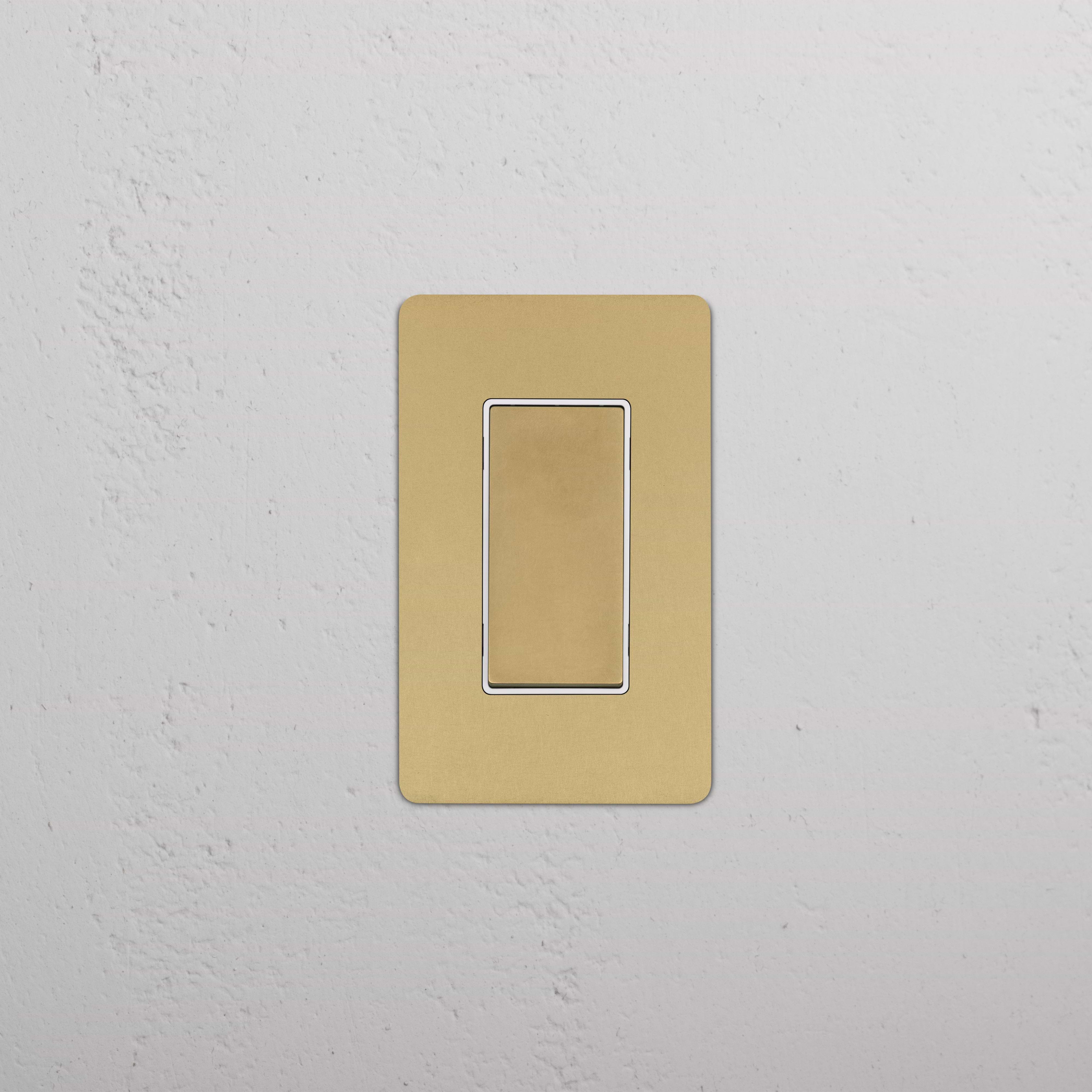Kew 1G Double Pole Rocker Switch in antique brass white, shown mounted on a white wall.