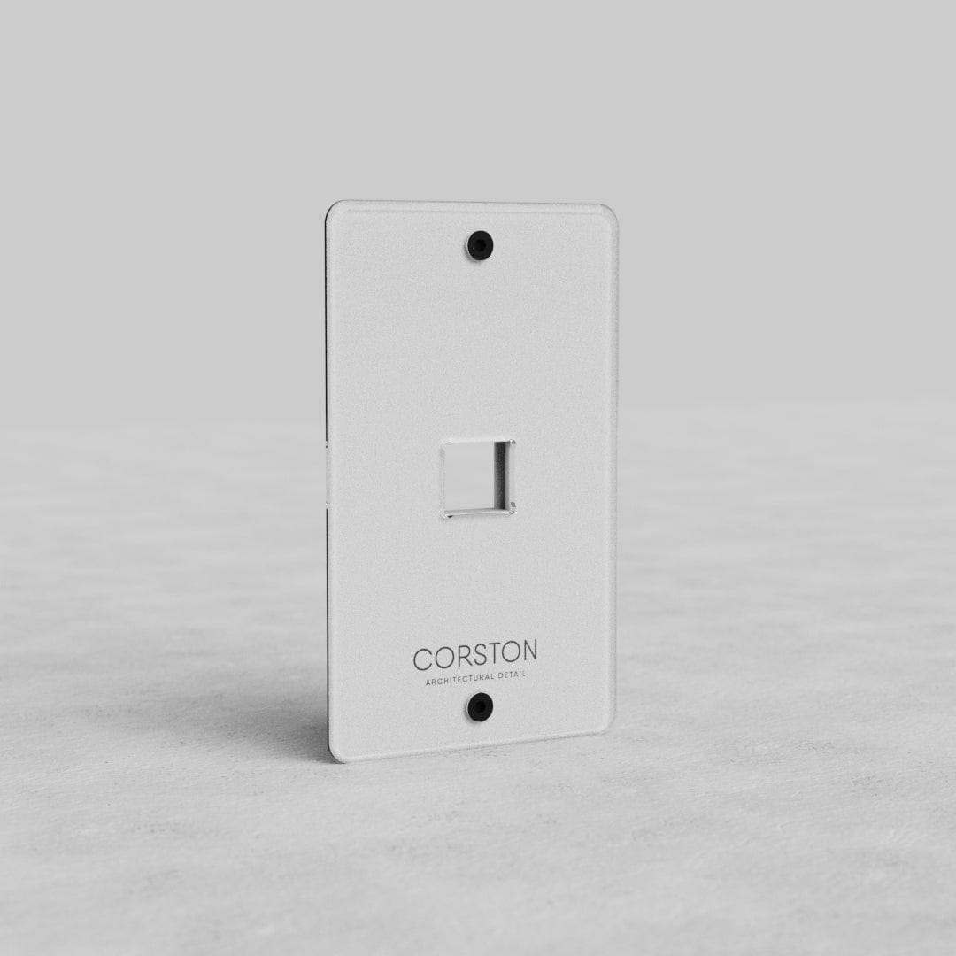 Clear 1G Keystone Plate Kew US with central cutout, white finish, screw holes, and Corston branding.