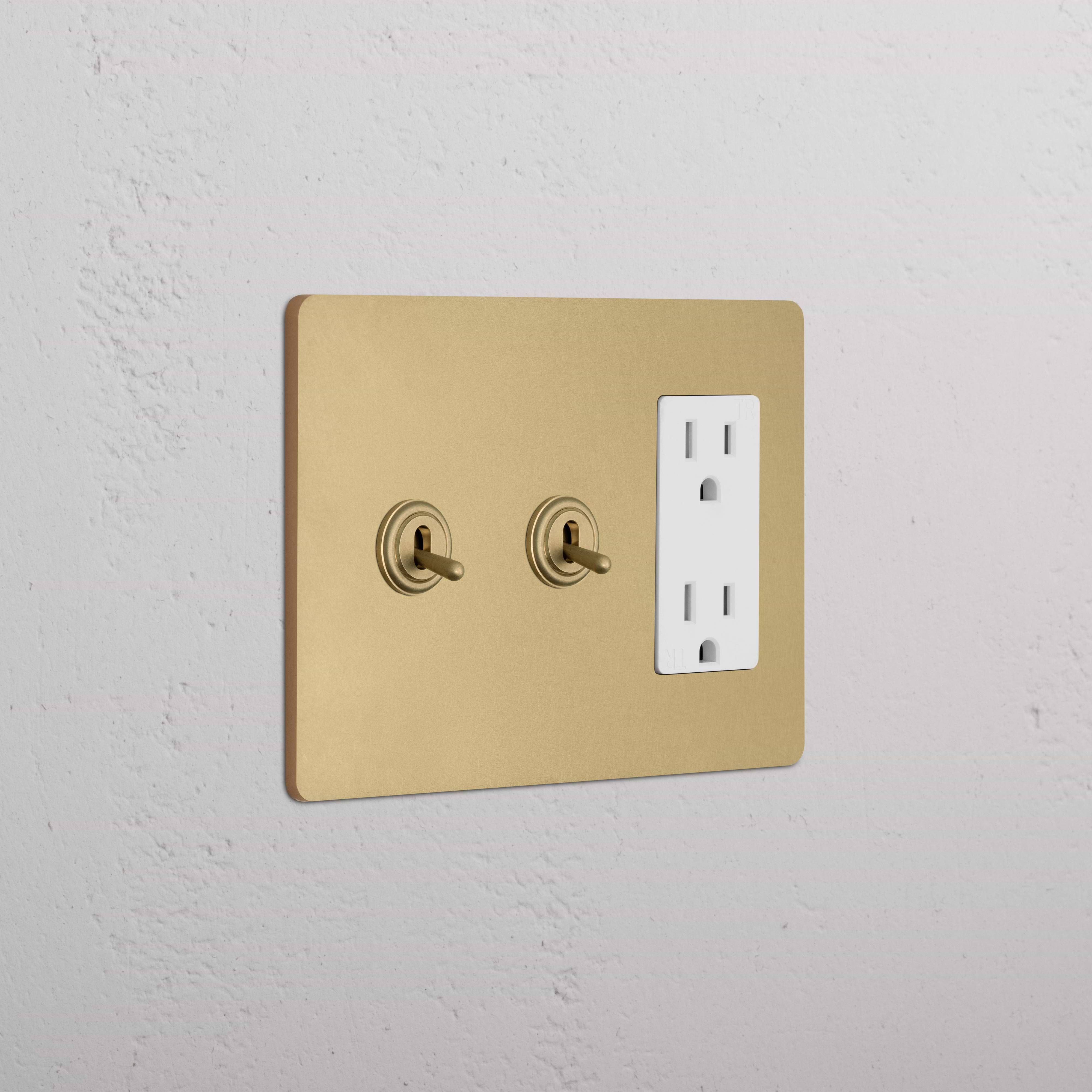 Antique Brass White Grove 3G wall plate with two toggle switches and a double power outlet.