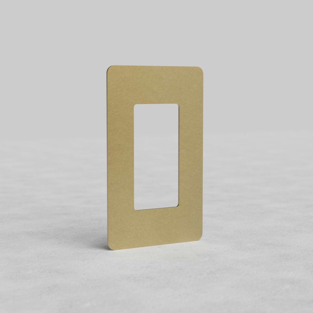 Rectangular 1G Outlet Plate Kew US in antique brass, with central cutout, on plain background.