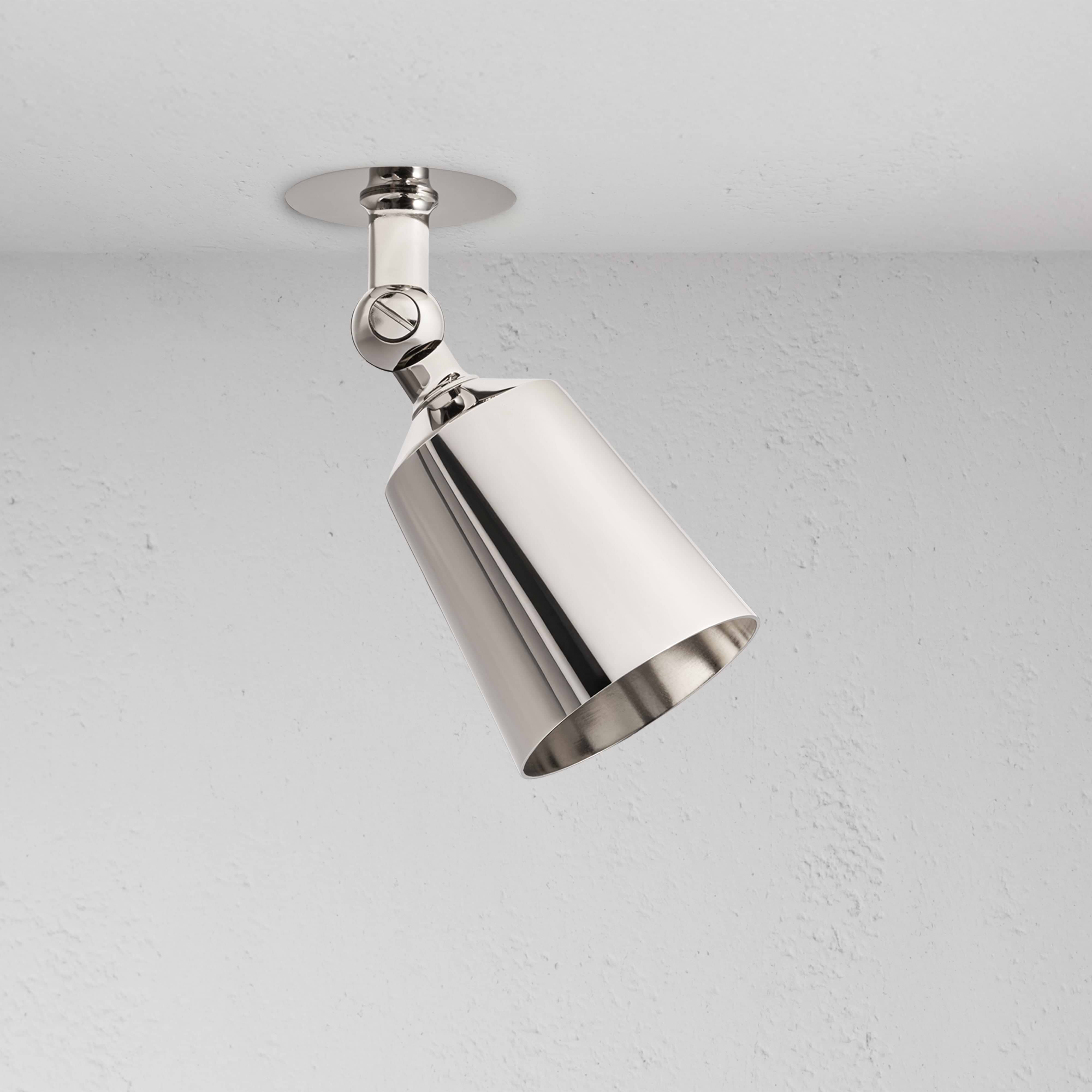 Perryn Single 50mm Spotlight in polished nickel, angled downward, mounted on a white ceiling.