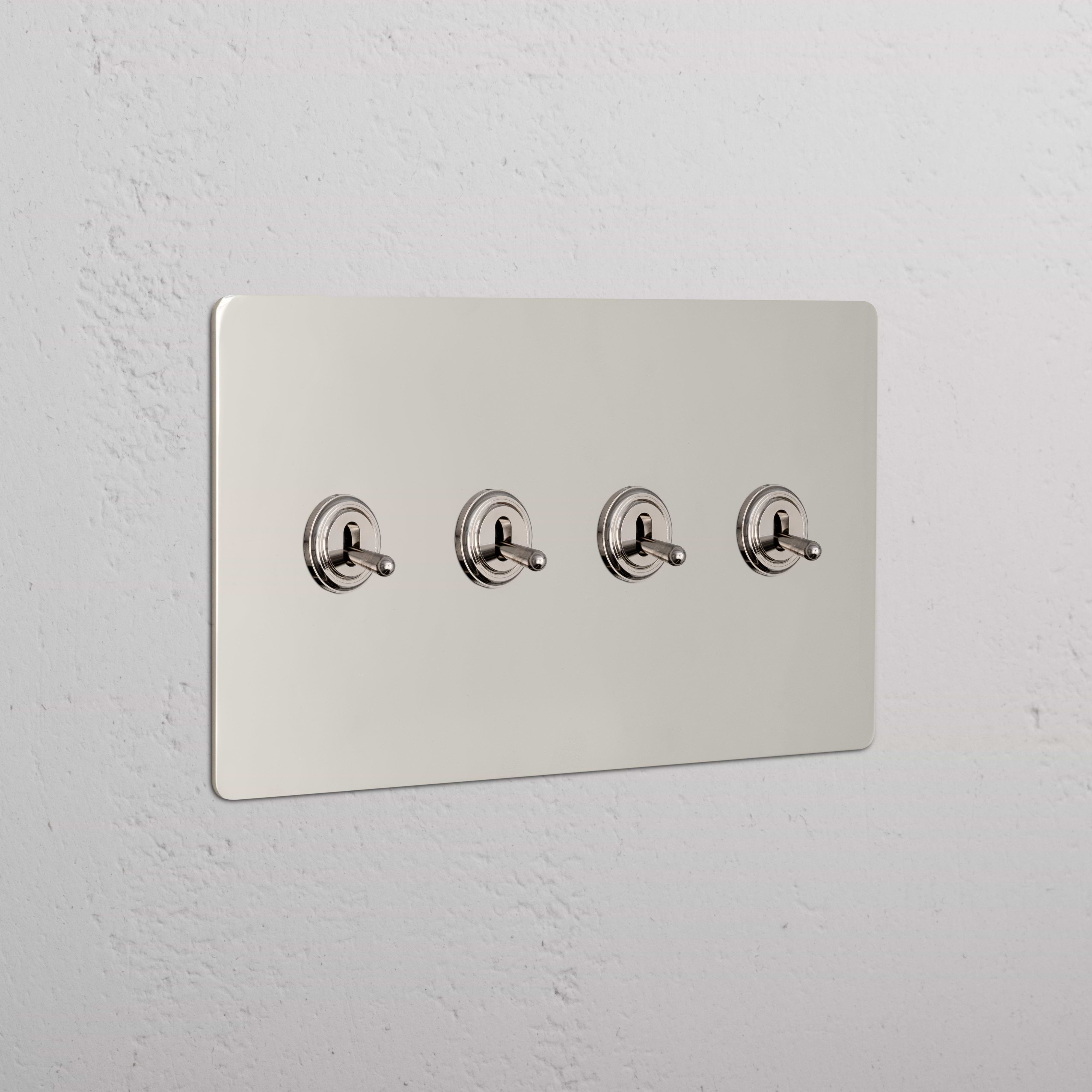 Kew 4G Toggle Switch in Polished Nickel with four horizontal toggles, mounted on a white wall.