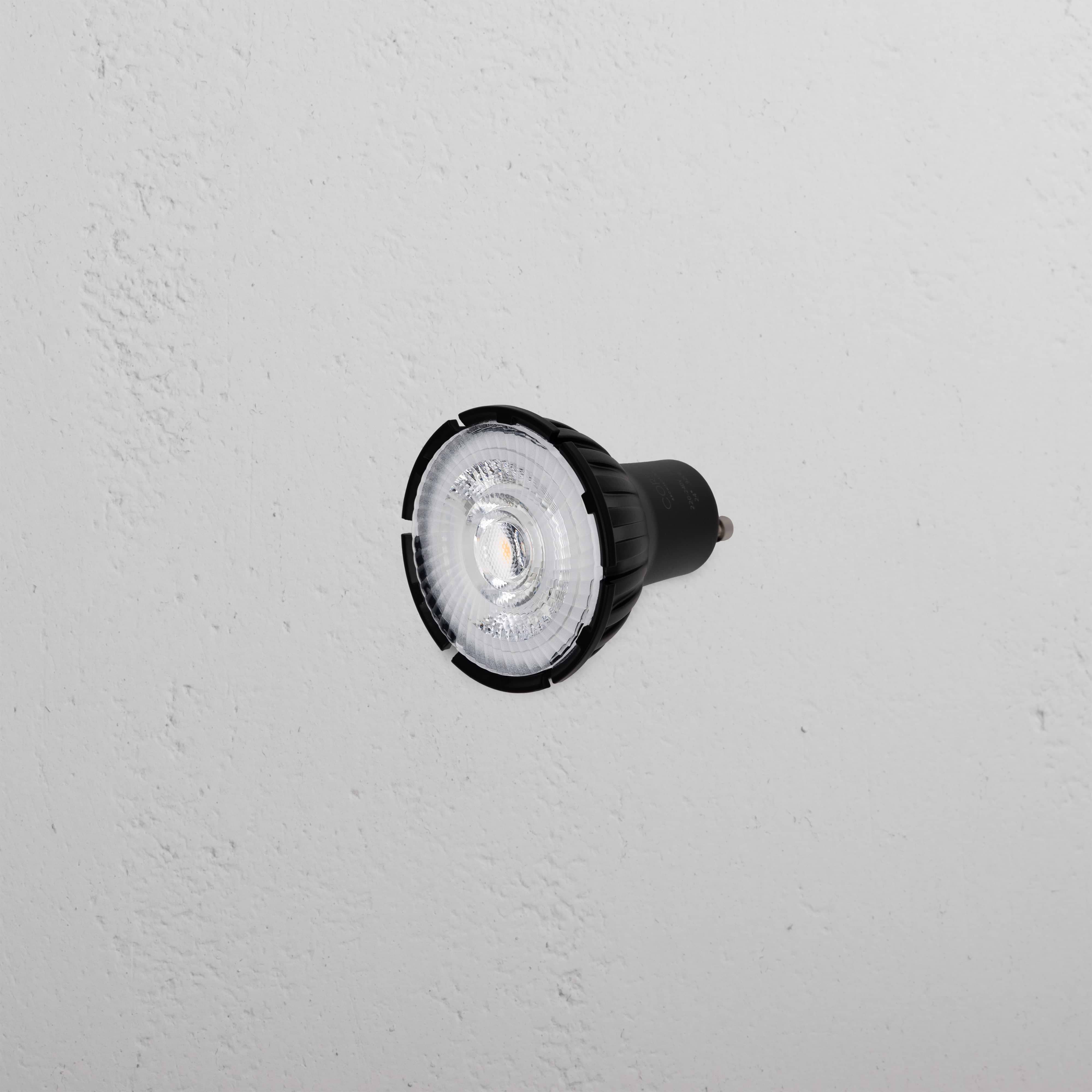 Arthur 7.5W 50mm LED GU10 24° Bulb with black casing displayed against a textured white background.