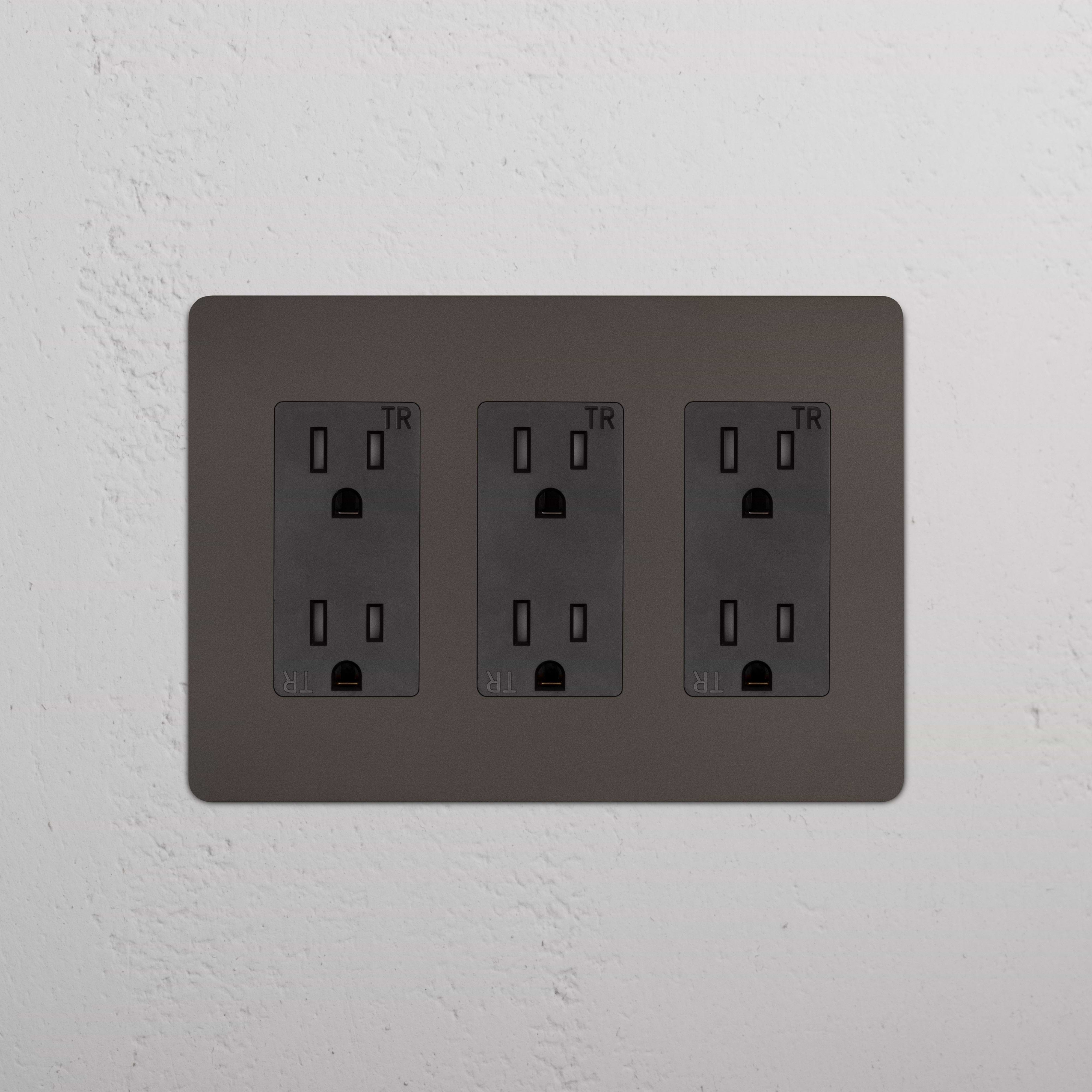 Kew 3G Outlet in Bronze Black finish with three black electrical sockets on a brushed metal wall plate.
