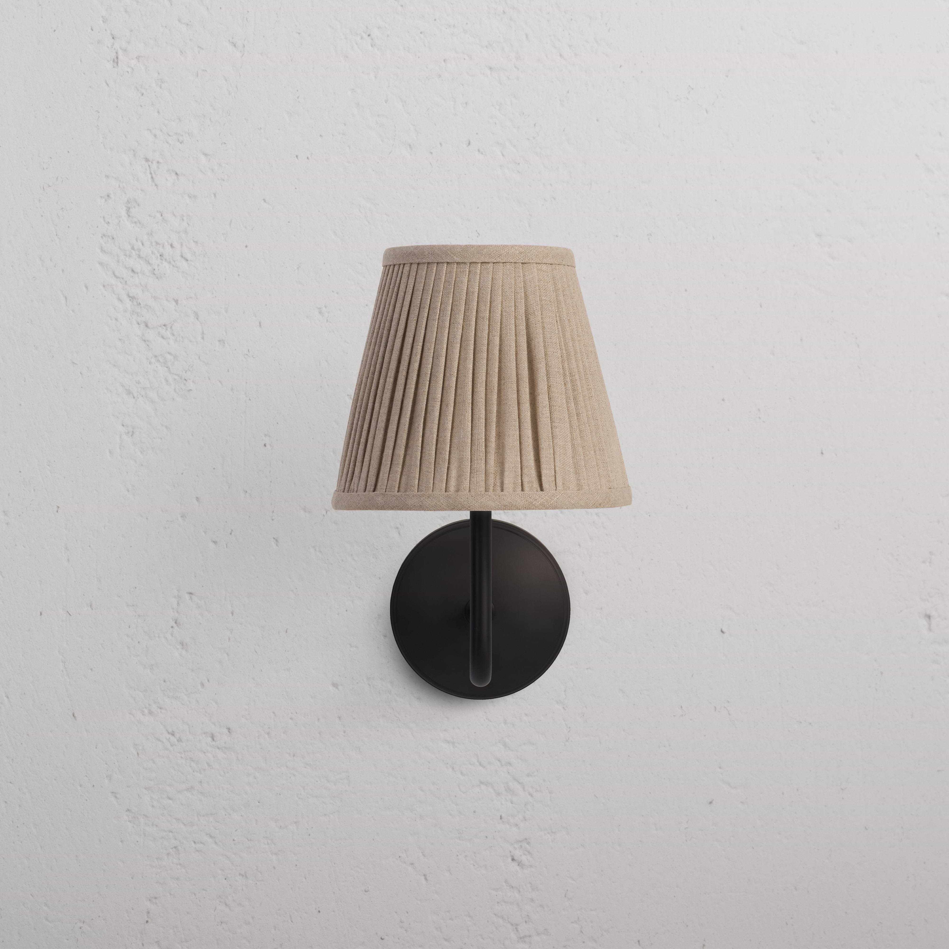 Malvern Medium Wall Light in Natural Beige with bronze finish, pleated lampshade, and circular base on wall.