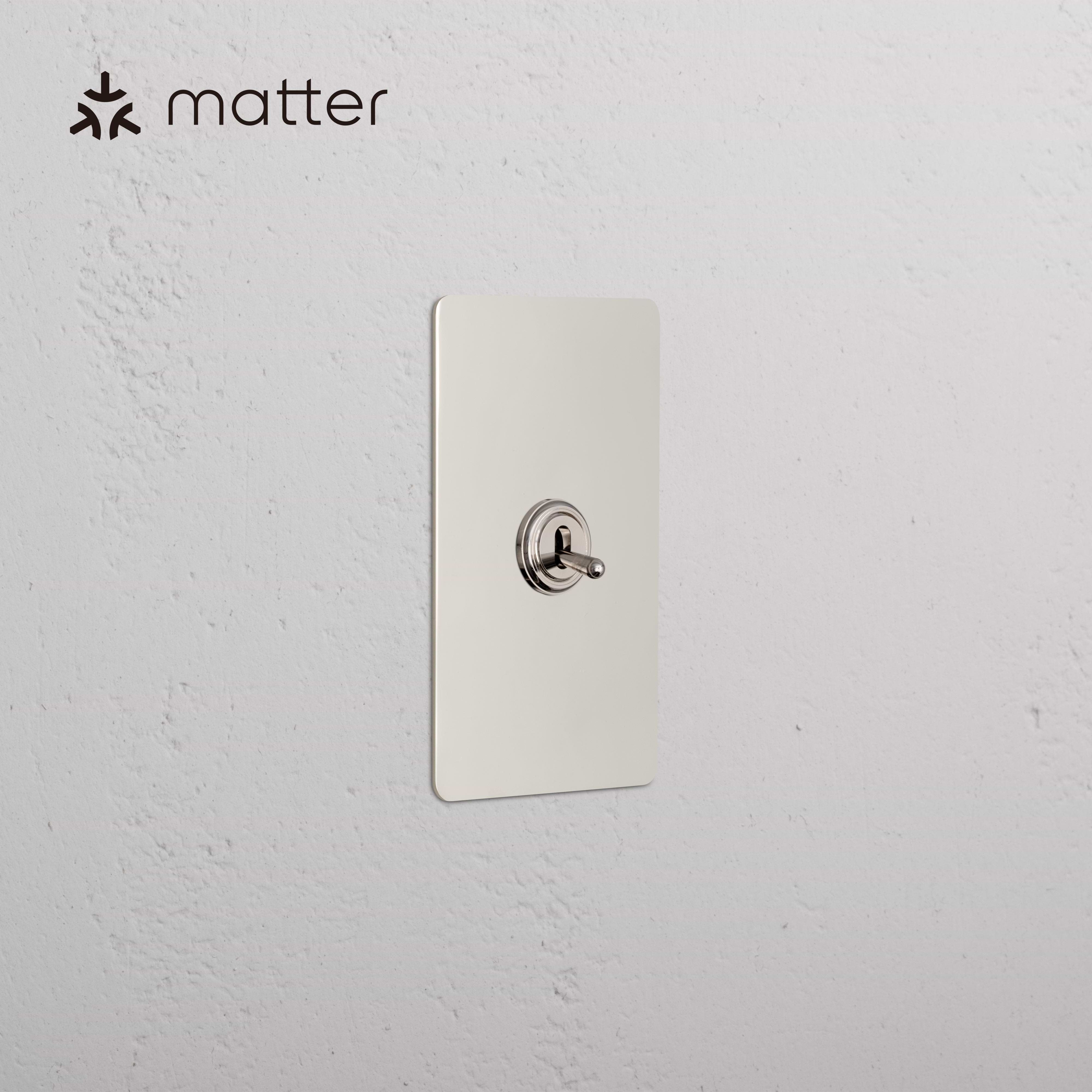 Kew 1G Smart Retractive Toggle Switch in polished nickel finish, mounted on a white wall with Matter logo.