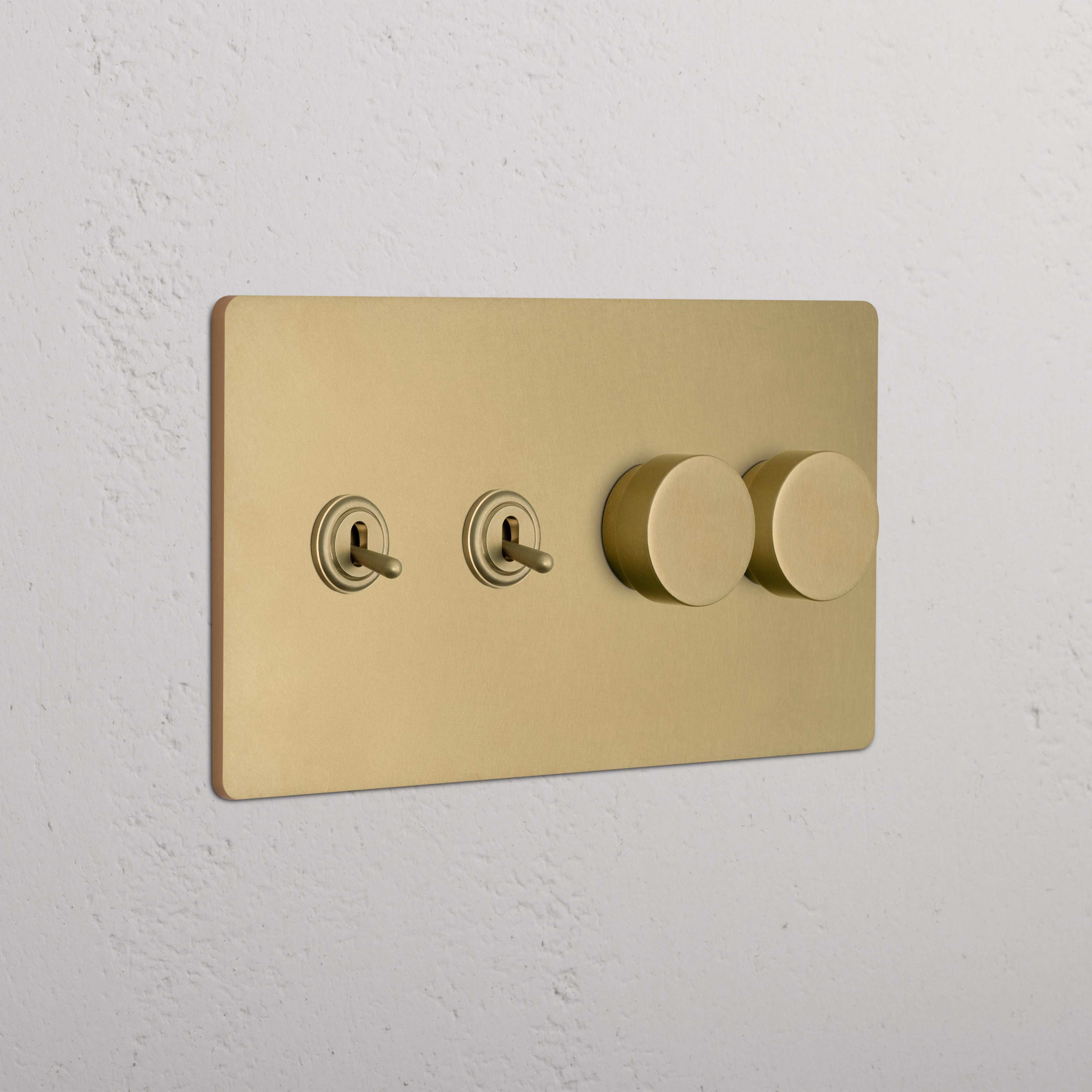 Grove 4G switch in antique brass with 2 toggle and 2 dimmer switches, mounted on a white wall.