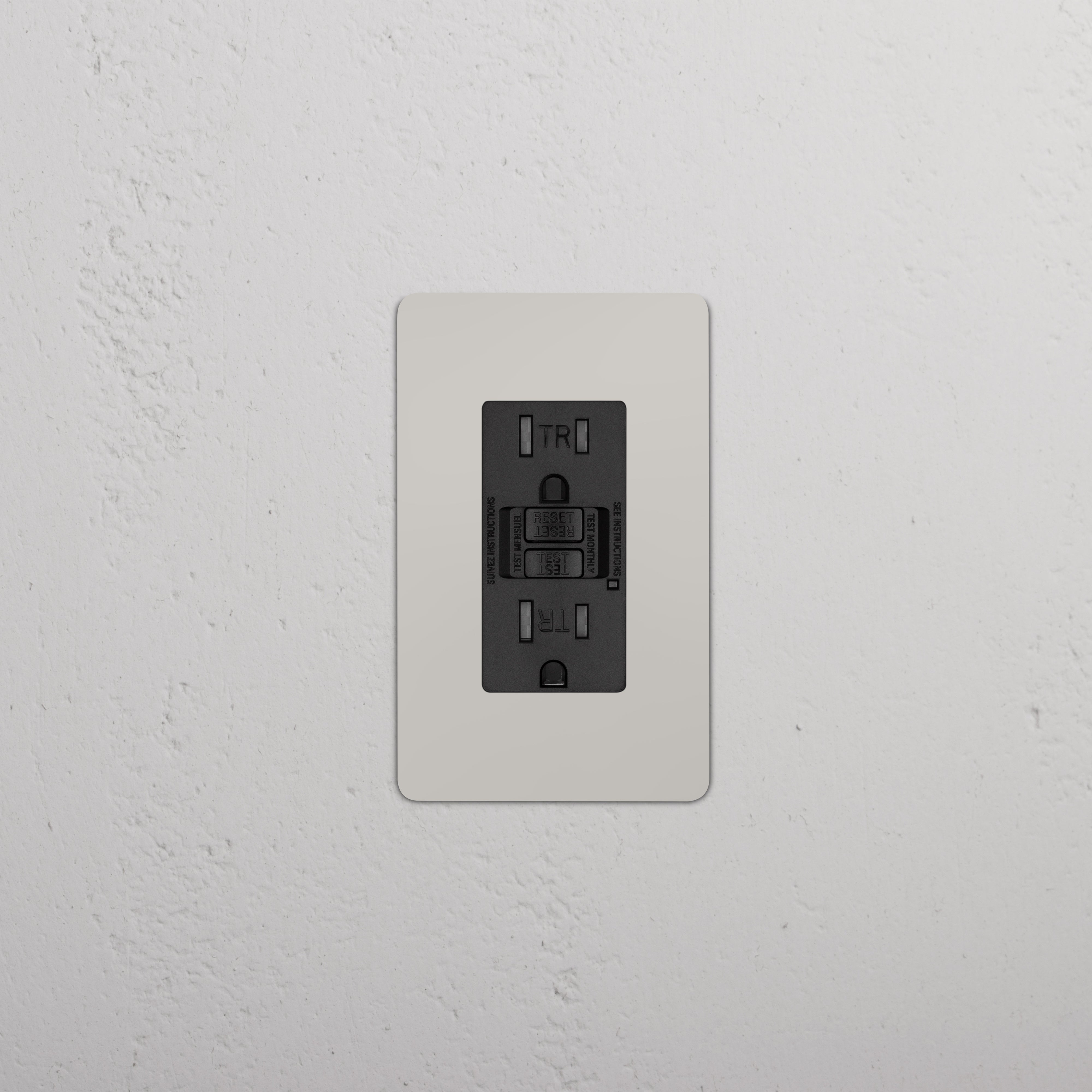 Kew 1G 15A GFCI Outlet in Polished Nickel Black with two sockets and test/reset buttons on a wall.