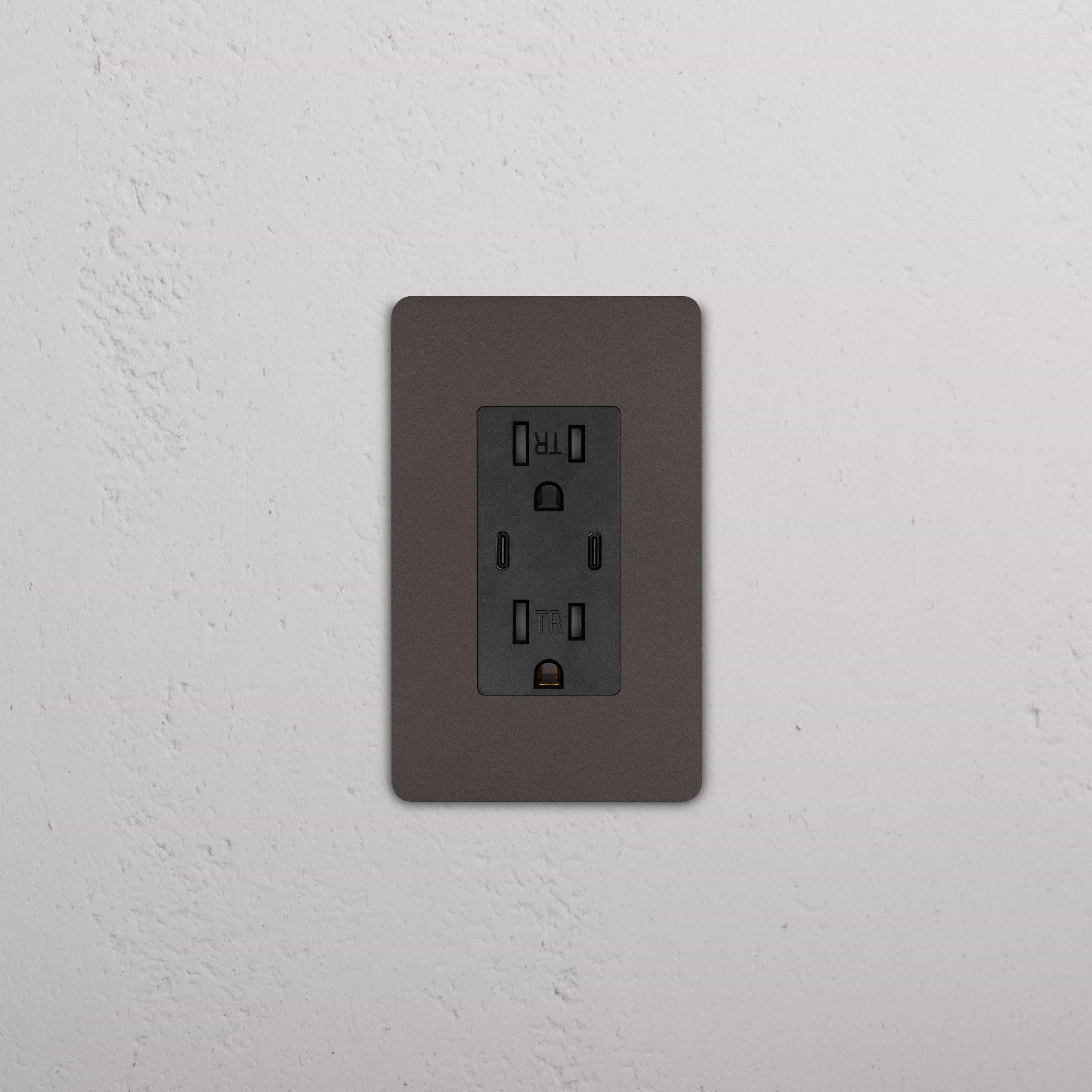 Grove 1G 15A USB Outlet in Bronze Black with a dark faceplate, installed on a white textured wall.