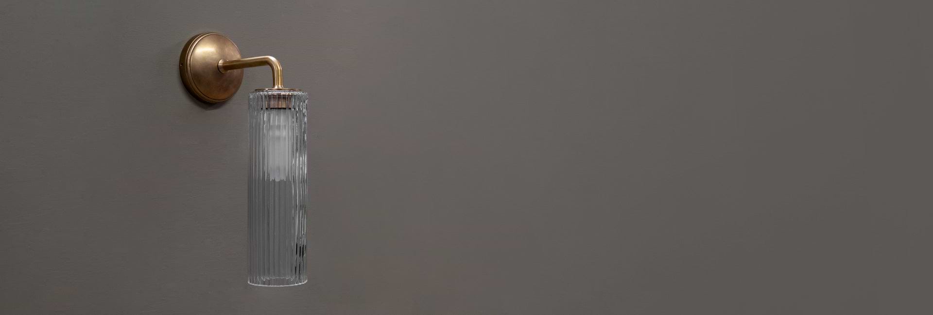 Antique brass wall light with fluted glass by Corston