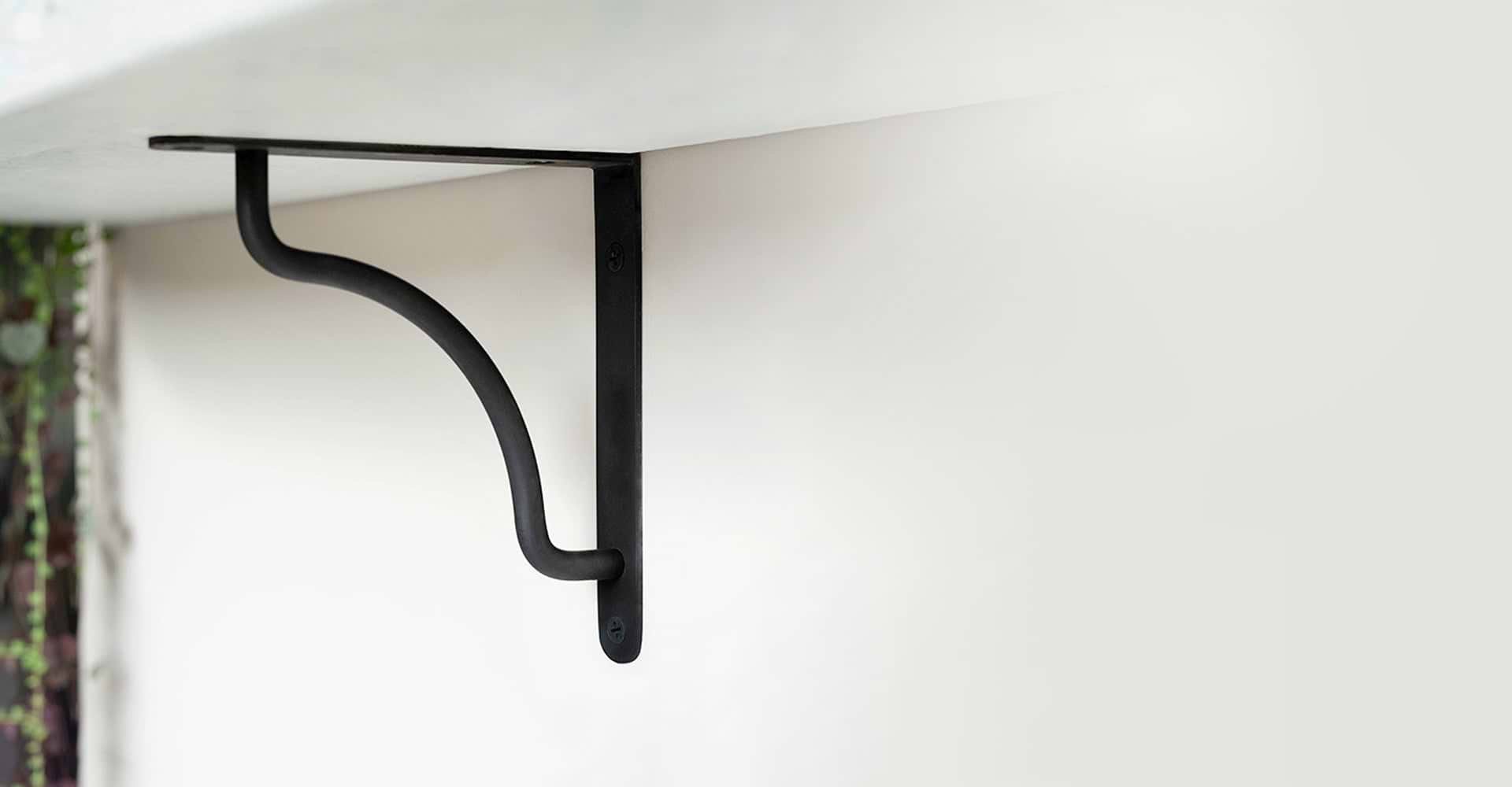 bronze shelf brackets with white marble shelves