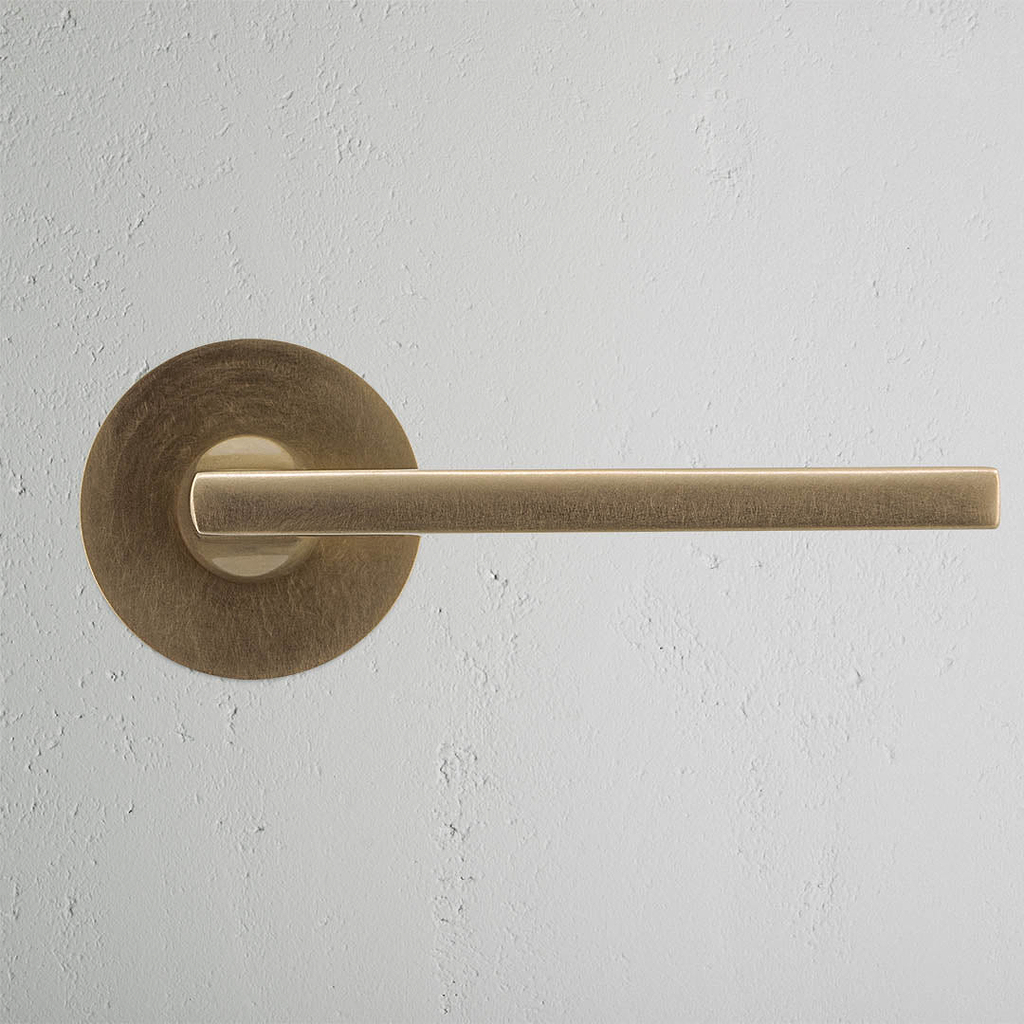 Clayton Sprung Door Handle With Flush Rose Antique Brass | Door