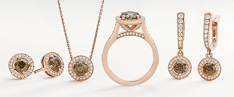 Brown diamond earring studs, a pendant, a ring, and drop earring set