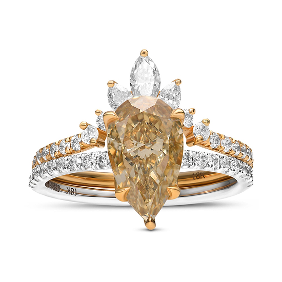 An engagement and wedding ring set featuring a pear-shaped fancy brownish yellow diamond with round brilliant cut side stones set in 18K white and yellow gold.