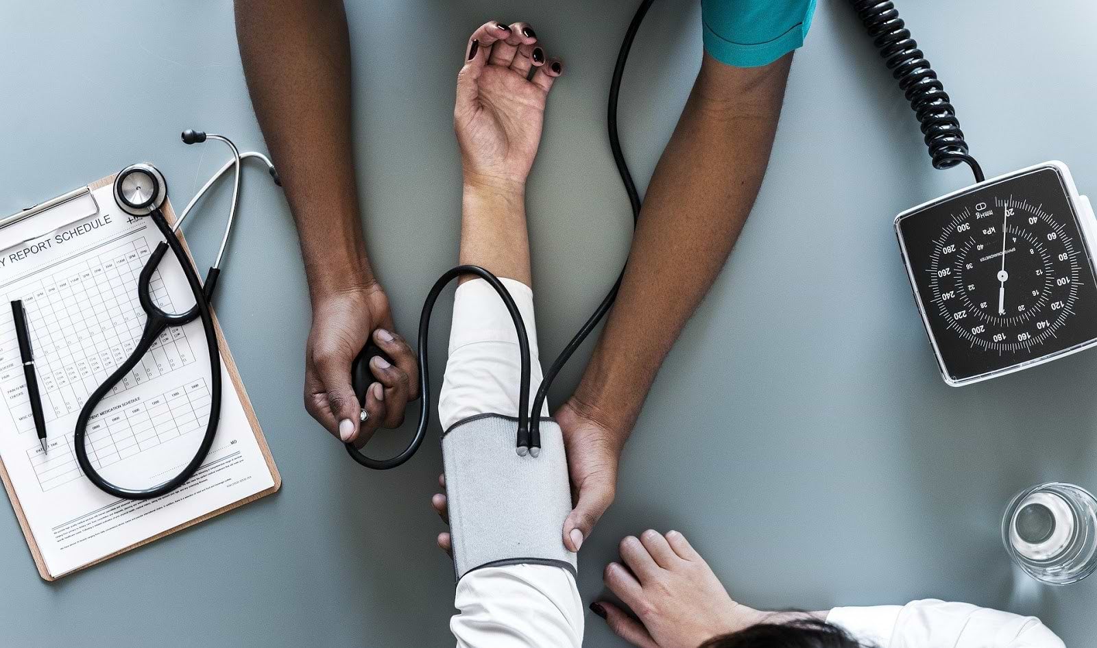 How to get rid of bloating: A doctor checks a patient's blood pressure